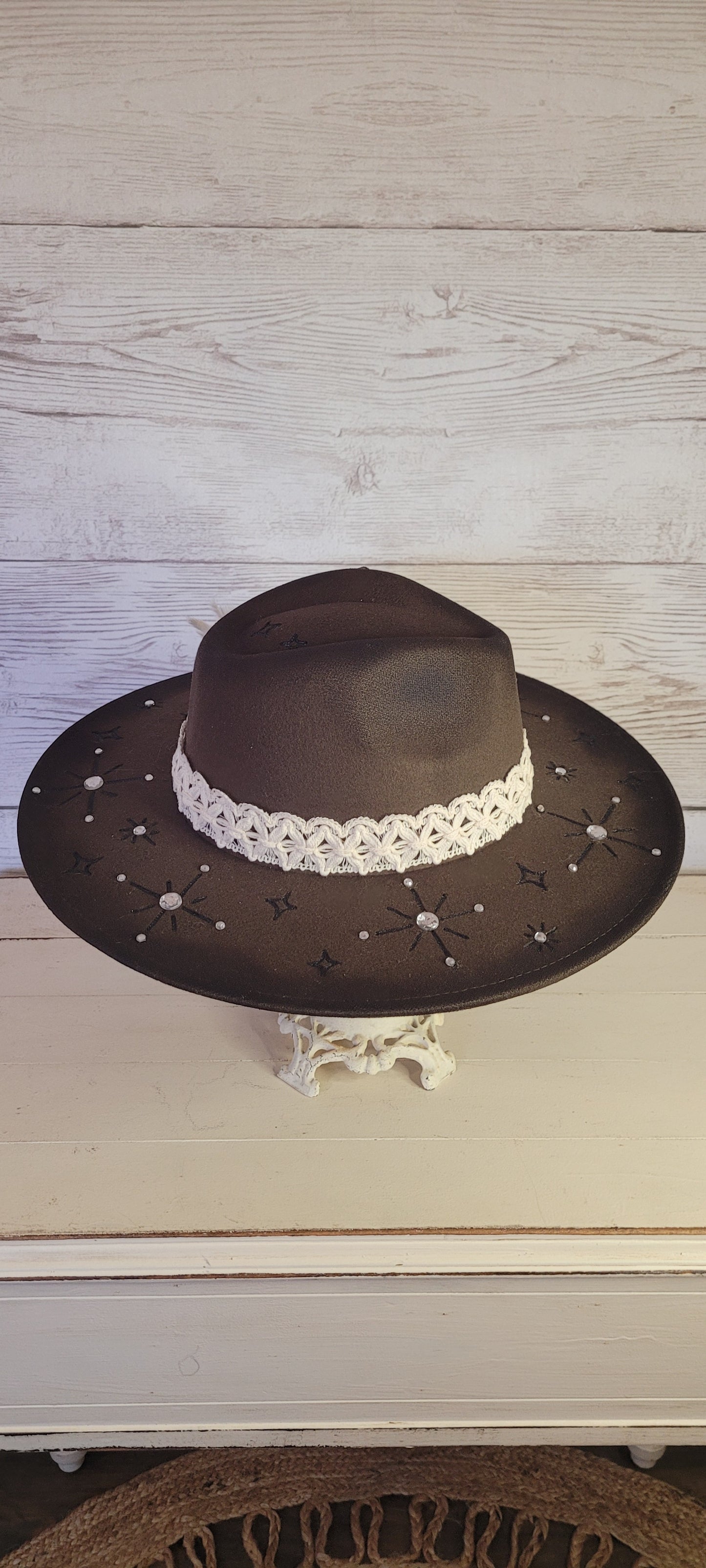 Features engraved stars & diamonds Rhinestone details throughout, pampas, crystal brooch, & playing card Felt hat Flat brim 65% polyester and 35% cotton Ribbon drawstring for hat size adjustment Head Circumference: 24" Crown Height: 5" Brim Length: 15.75" Brim Width: 14.5" Branded & numbered inside crown Custom designed by Kayla