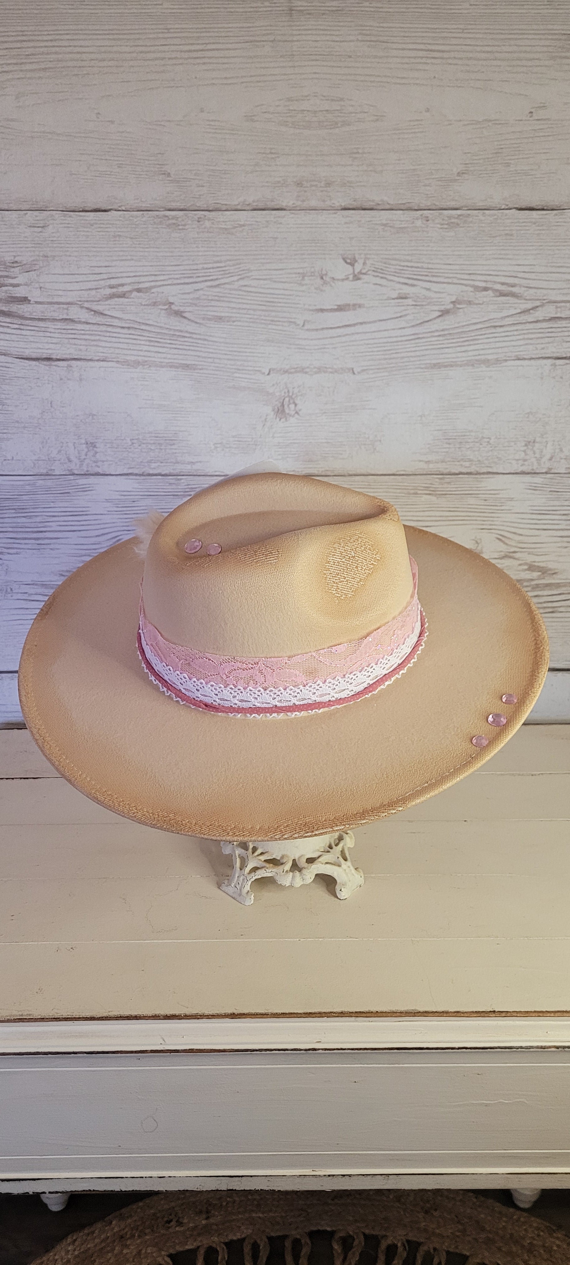 Pink ribbon & lace, natural lace ribbon, pampas, AB rhinestone brooch, light pink rhinestones & playing card Felt hat Flat brim 65% polyester and 35% cotton Ribbon drawstring for hat size adjustment Head Circumference: 24" Crown Height: 5" Brim Length: 15.75" Brim Width: 14.5" Branded & numbered inside crown Custom burned & designed by Kayla