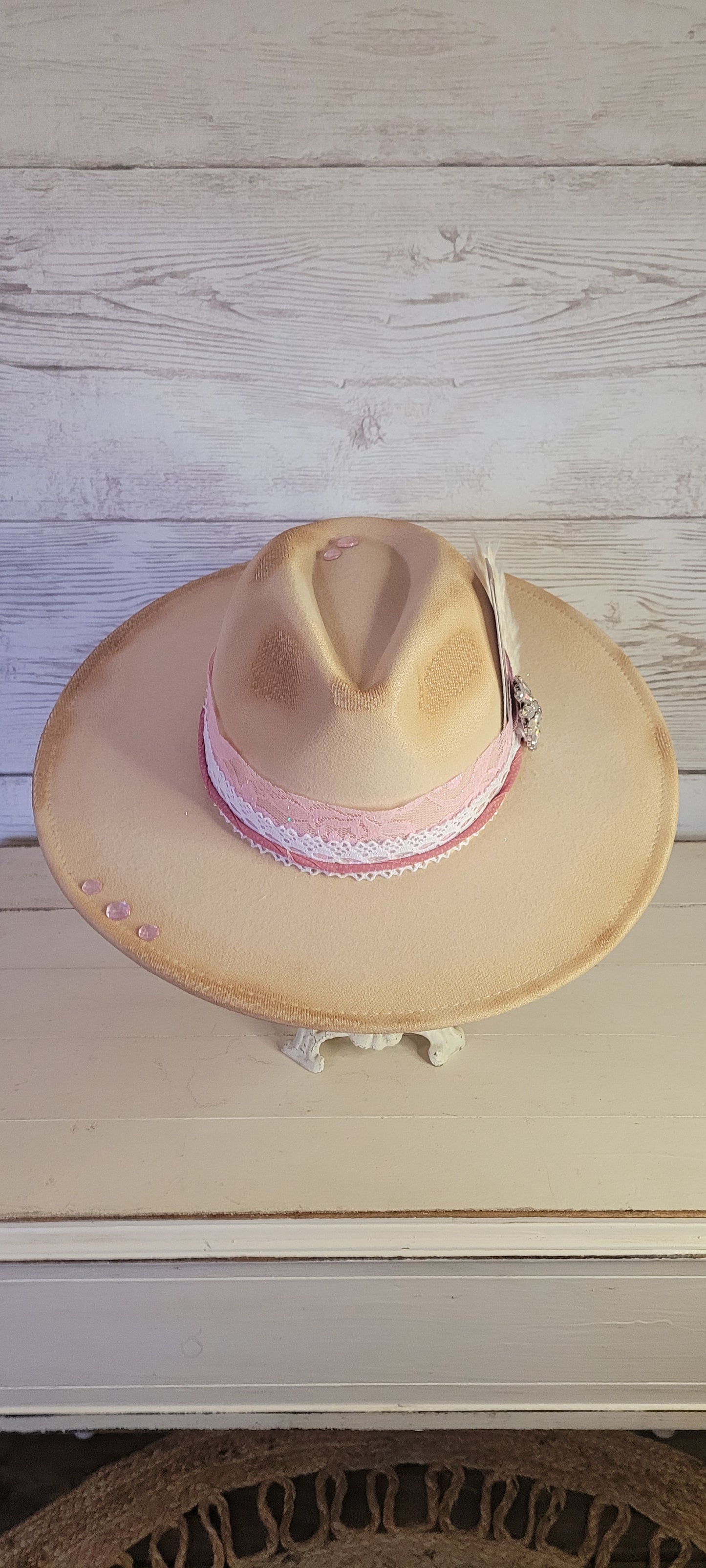Pink ribbon & lace, natural lace ribbon, pampas, AB rhinestone brooch, light pink rhinestones & playing card Felt hat Flat brim 65% polyester and 35% cotton Ribbon drawstring for hat size adjustment Head Circumference: 24" Crown Height: 5" Brim Length: 15.75" Brim Width: 14.5" Branded & numbered inside crown Custom burned & designed by Kayla