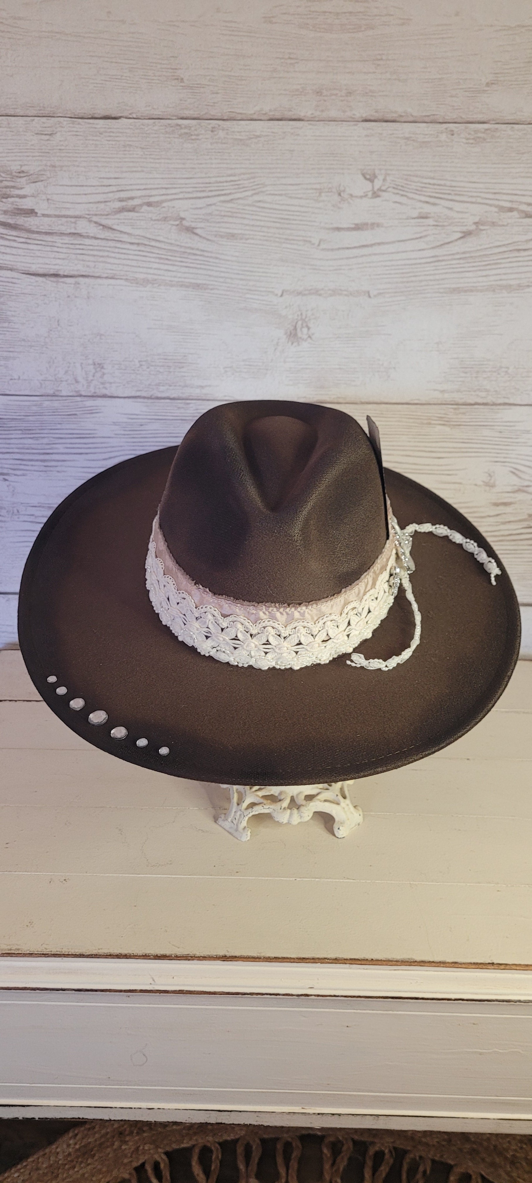 Features rhinestone details on brim, crystal brooches, & playing card, light rose ribbon, natural lace ribbon, pearl ribbon Felt hat Flat brim 65% polyester and 35% cotton Ribbon drawstring for hat size adjustment Head Circumference: 24" Crown Height: 5" Brim Length: 15.75" Brim Width: 14.5" Branded & numbered inside crown Custom designed by Kayla
