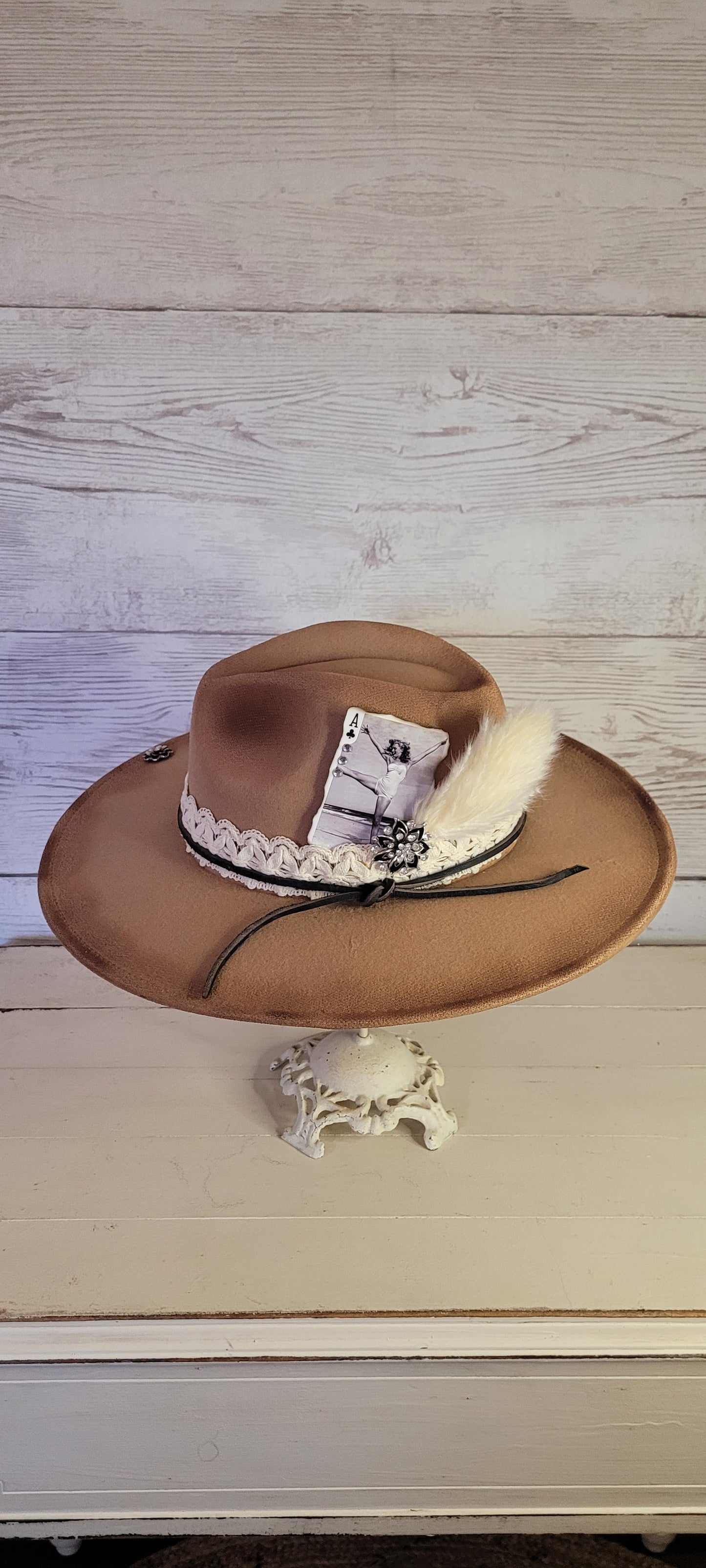 Features "I'm acting up" engraving Lace ribbon, leather band, pampas, rhinestone brooches, playing card Felt hat Flat brim 100% polyester Ribbon drawstring for hat size adjustment Head Circumference: 24" Crown Height: 5" Brim Length: 15.75" Brim Width: 14.5" Branded & numbered inside crown Custom burned & engraved by Kayla