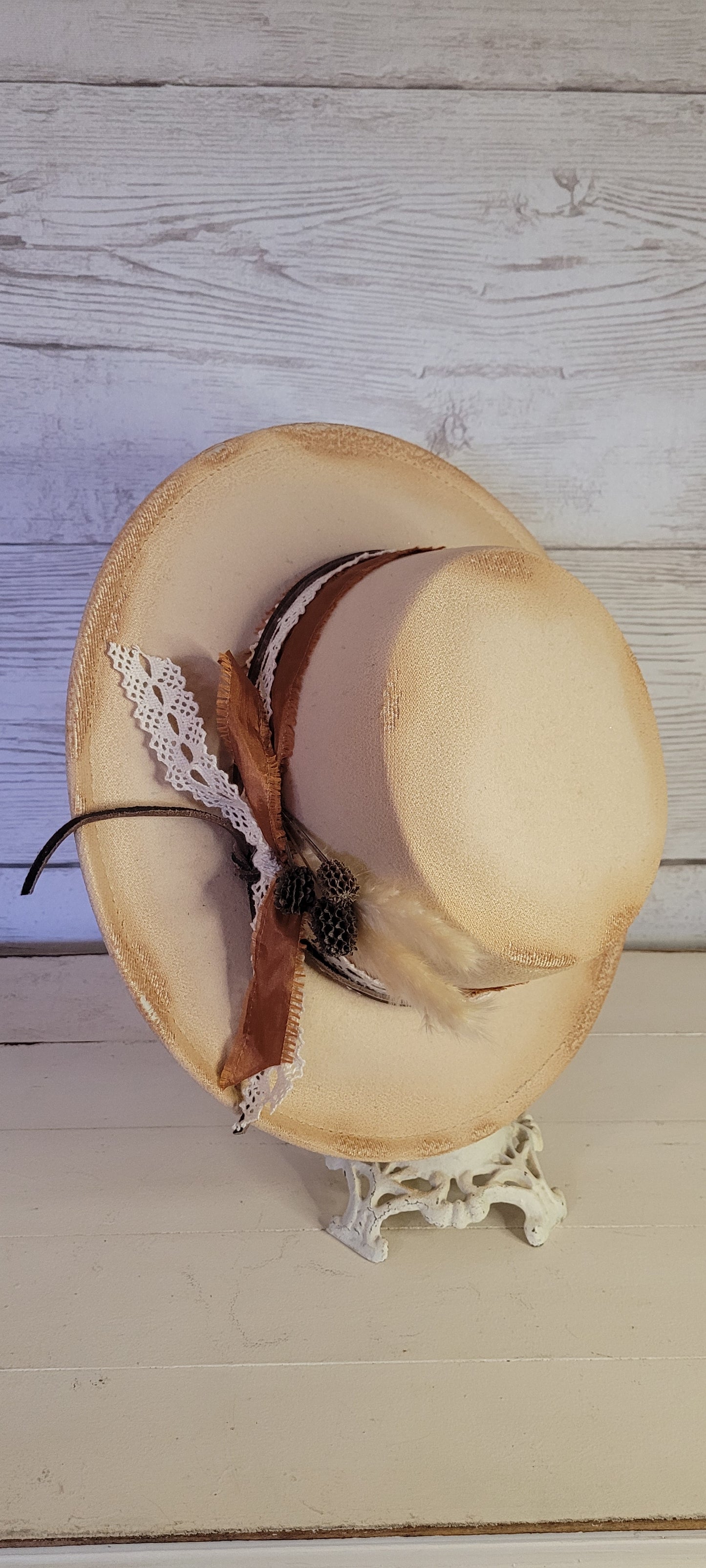 Lace ribbon, frayed lace ribbon, leather band, pampas, pine cones Felt hat Flat brim 100% polyester Ribbon drawstring for hat size adjustment Head Circumference: 24" Crown Height: 3.5" Brim Length: 13.5" Brim Width: 12.75" Branded & numbered inside crown Custom burned & engraved by Kayla
