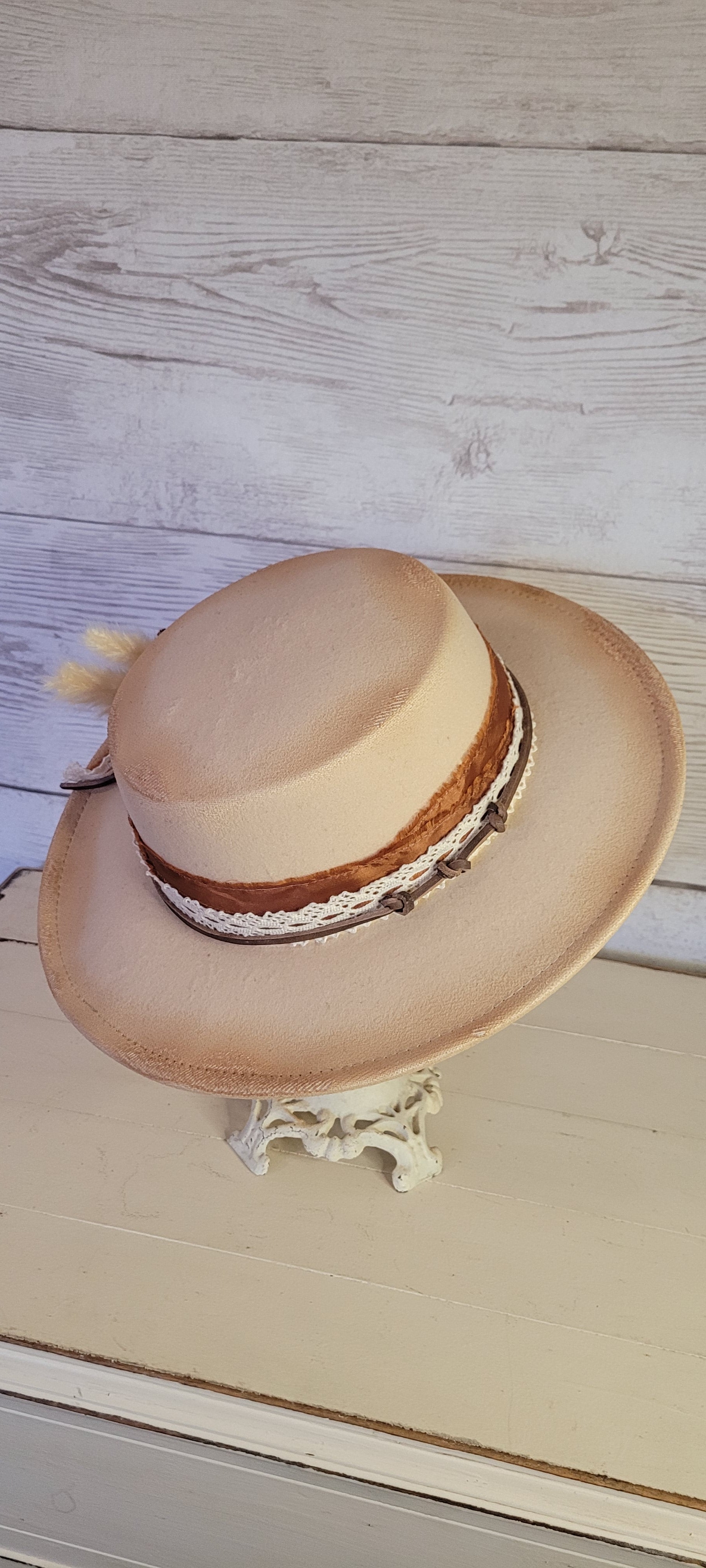 Lace ribbon, frayed lace ribbon, leather band, pampas, pine cones Felt hat Flat brim 100% polyester Ribbon drawstring for hat size adjustment Head Circumference: 24" Crown Height: 3.5" Brim Length: 13.5" Brim Width: 12.75" Branded & numbered inside crown Custom burned & engraved by Kayla