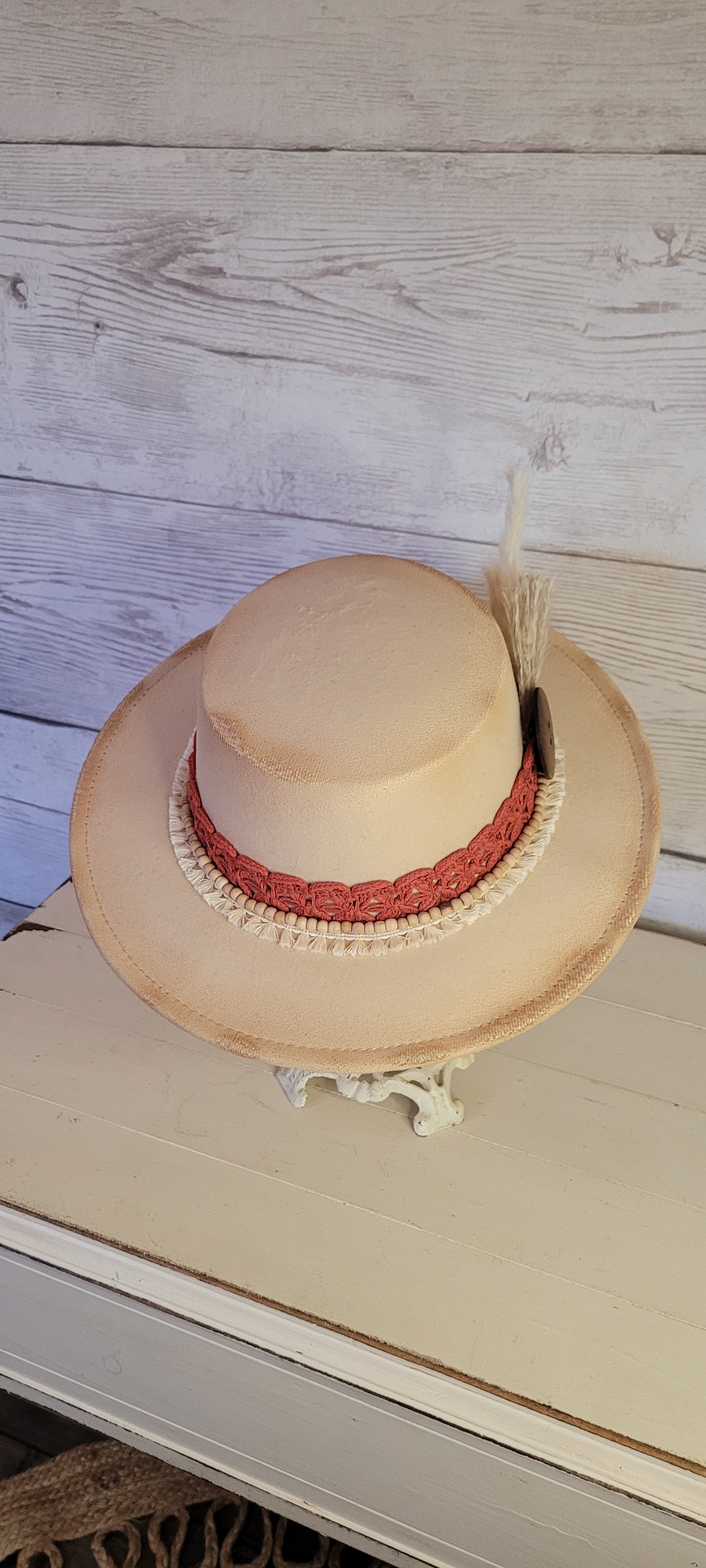 Lace ribbon, tassel ribbon, wooden bead band, button, & pampas Felt hat Flat brim 100% polyester Ribbon drawstring for hat size adjustment Head Circumference: 24" Crown Height: 3.5" Brim Length: 13.5" Brim Width: 12.75" Branded & numbered inside crown Custom burned by Kayla