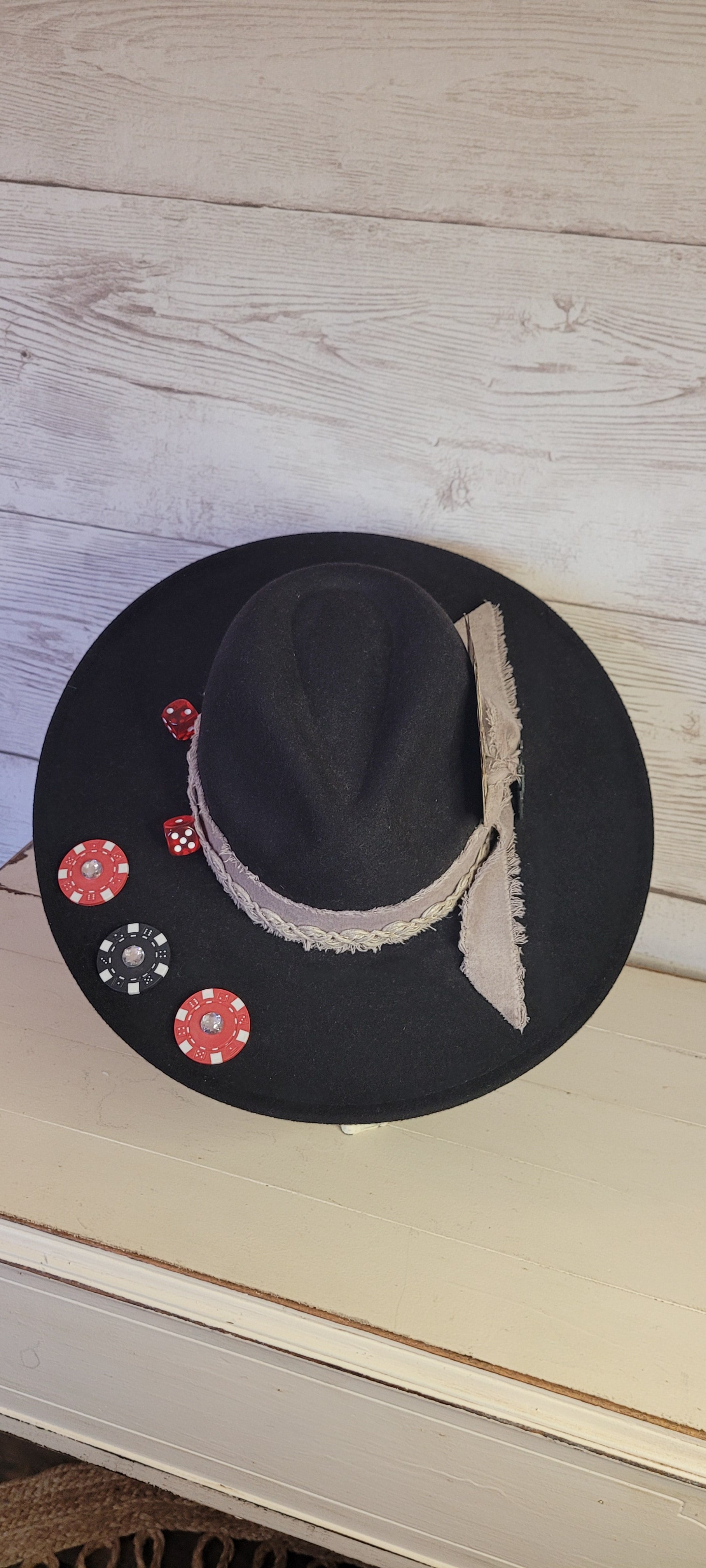 Features poker chips, dice, rhinestones, playing cards, natural frayed & lace ribbon, & metal horseshoe Felt hat Flat brim 35% cotton and 65% polyester Ribbon drawstring for hat size adjustment Head Circumference: 24" Crown Height: 5" Brim Length: 15.75" Brim Width: 14.5" Branded & numbered inside crown Custom designed by Kayla