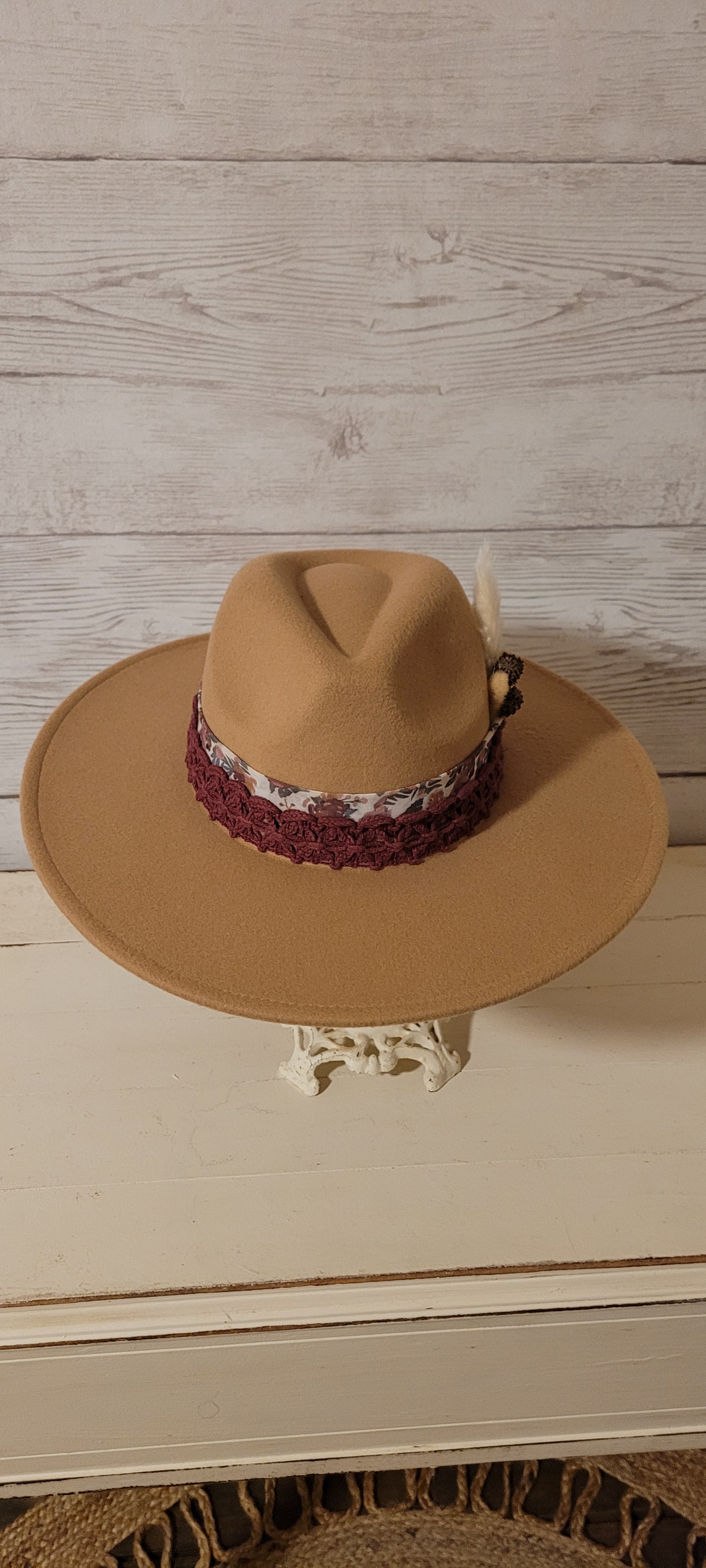 Sheer floral ribbon, lace ribbon, pampas, cattails, pine cones Felt hat Flat brim 100% polyester Ribbon drawstring for hat size adjustment Head Circumference: 24" Crown Height: 5" Brim Length: 15.75" Brim Width: 14.5" Branded & numbered inside crown Custom designed by Kayla