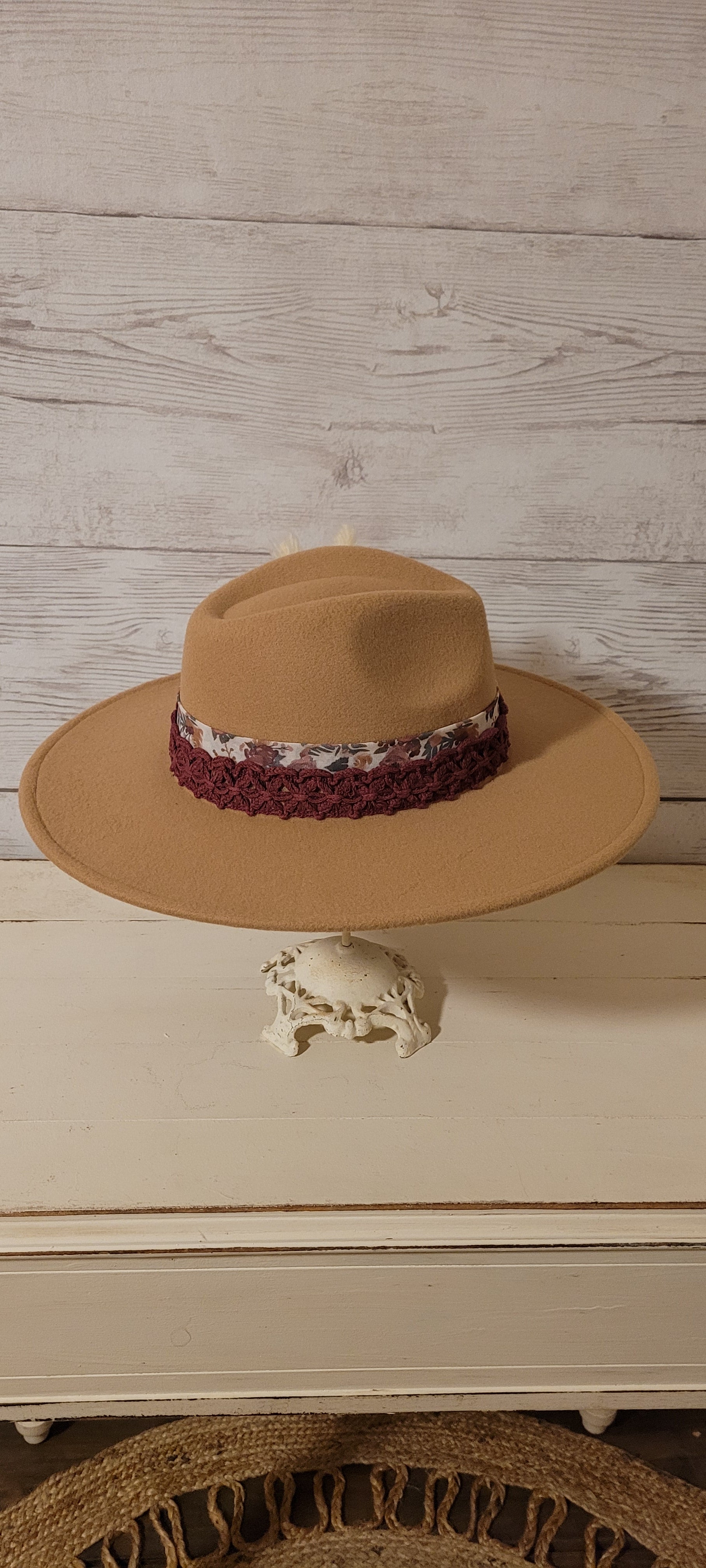 Sheer floral ribbon, lace ribbon, pampas, cattails, pine cones Felt hat Flat brim 100% polyester Ribbon drawstring for hat size adjustment Head Circumference: 24" Crown Height: 5" Brim Length: 15.75" Brim Width: 14.5" Branded & numbered inside crown Custom designed by Kayla