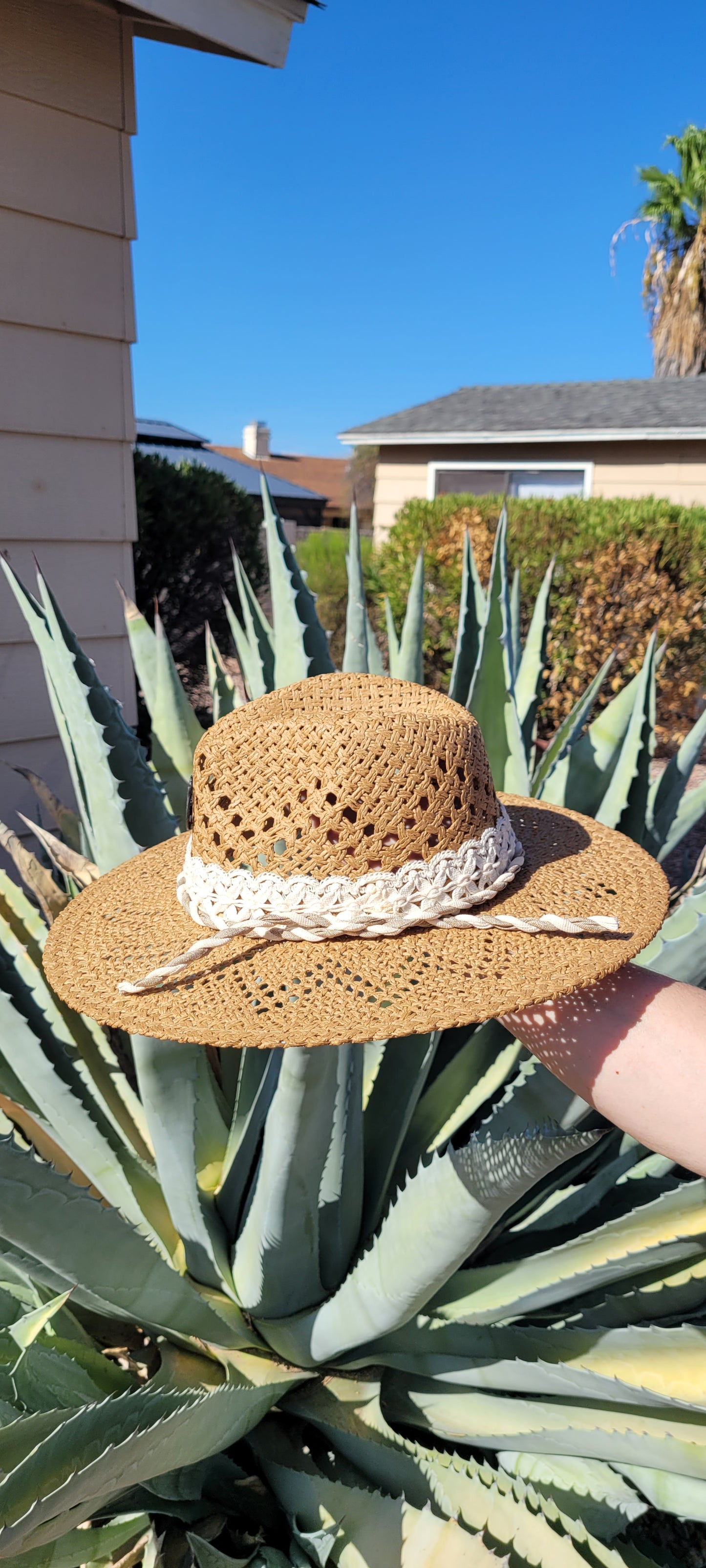 Lace ribbon, twisted gauze, metal horseshoes Straw hat Flat brim 65% polyester and 35% cotton Ribbon drawstring for hat size adjustment Head Circumference: 24" Crown Height: 5" Brim Length: 15.75" Brim Width: 14.75" Branded & numbered inside crown Custom designed by Kayla