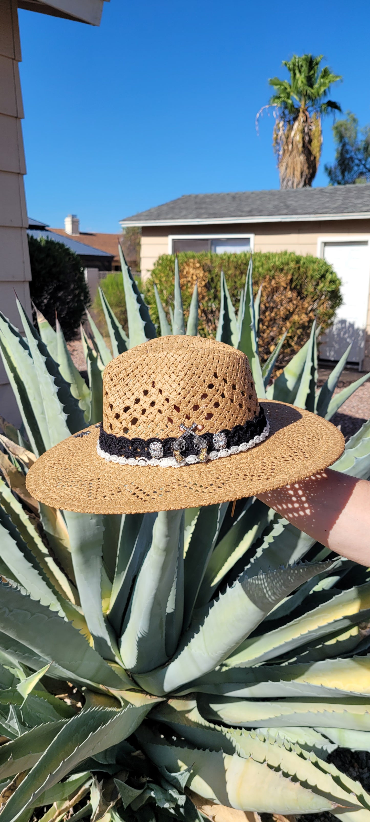 Lace ribbon, pearl ribbon, rowel (boot spur) pistol & decorative brooches Straw hat Flat brim 65% polyester and 35% cotton Ribbon drawstring for hat size adjustment Head Circumference: 24" Crown Height: 5" Brim Length: 15.75" Brim Width: 14.75" Branded & numbered inside crown Custom designed by Kayla