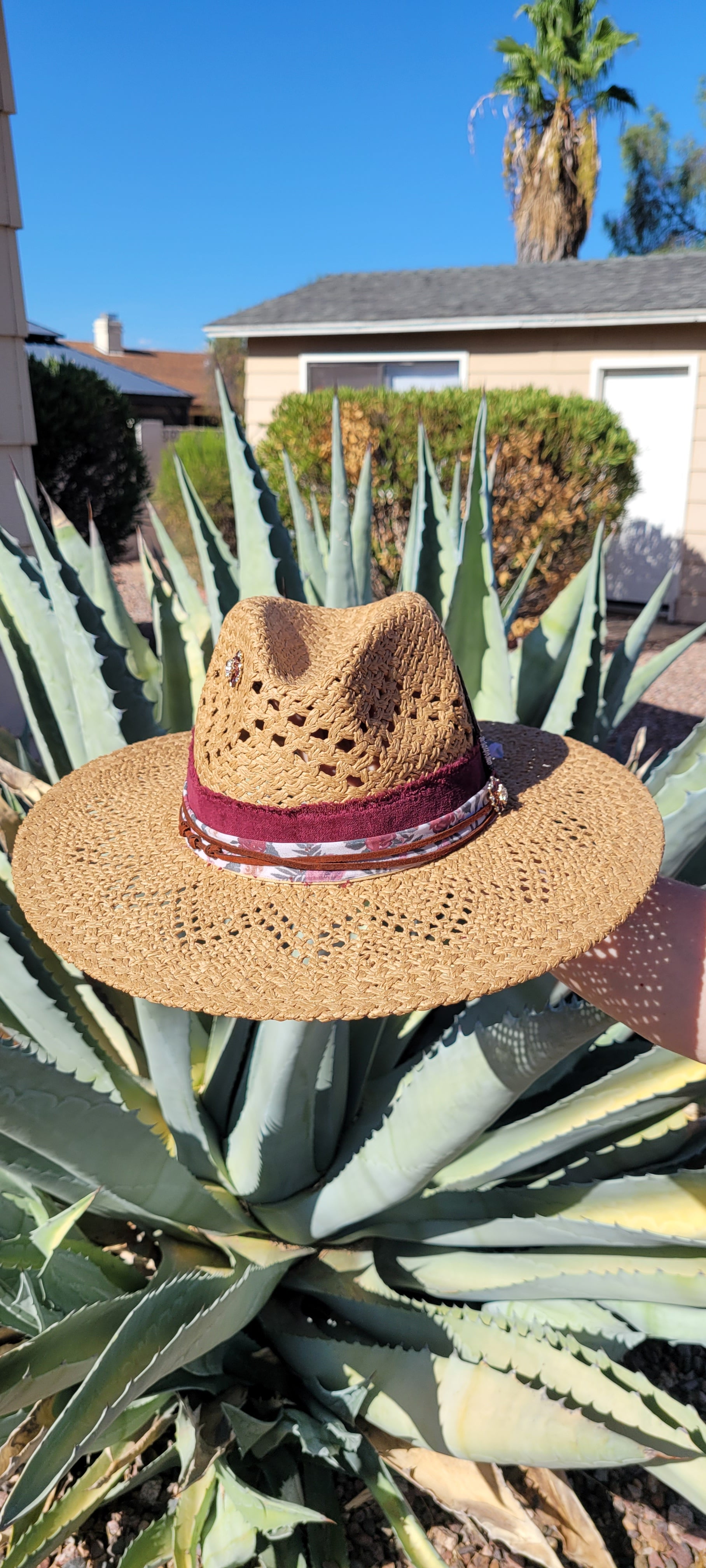 Features frayed velvet ribbon, sheer floral ribbon, suede band, saguaro cactus & flower brooches Straw hat Flat brim 65% polyester and 35% cotton Ribbon drawstring for hat size adjustment Head Circumference: 24" Crown Height: 5" Brim Length: 15.75" Brim Width: 14.75" Branded & numbered inside crown Custom designed by Kayla
