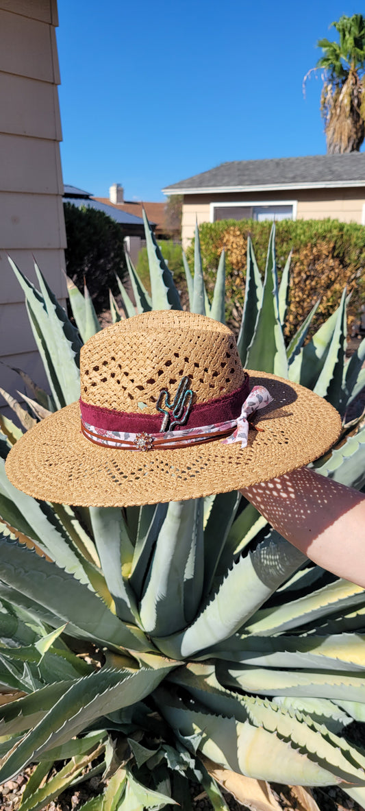Features frayed velvet ribbon, sheer floral ribbon, suede band, saguaro cactus & flower brooches Straw hat Flat brim 65% polyester and 35% cotton Ribbon drawstring for hat size adjustment Head Circumference: 24" Crown Height: 5" Brim Length: 15.75" Brim Width: 14.75" Branded & numbered inside crown Custom designed by Kayla