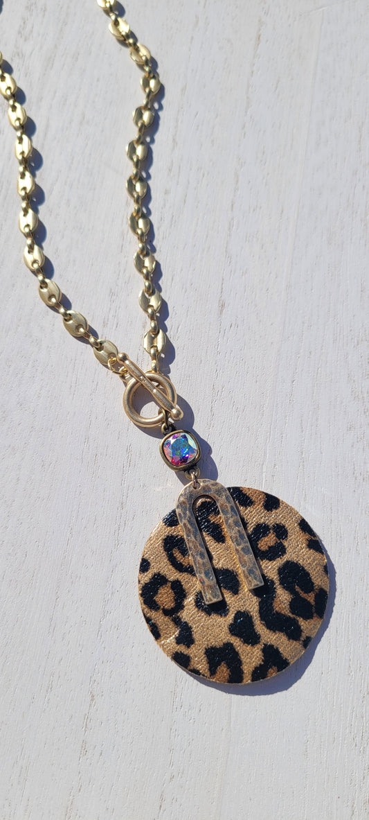 Pink Panache Necklace Color: Matte gold mariner toggle front chain necklace with bronze/AB 8mm cushion cut connector and leopard leather circle pendant Limited supply!