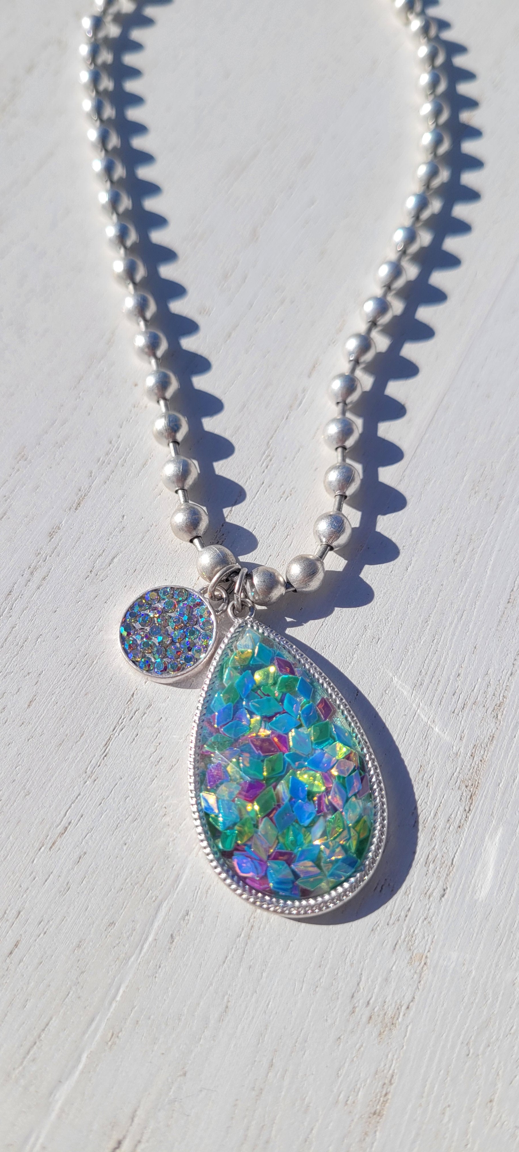 Pink Panache necklace Color: Silver ball chain necklace with multi-color confetti filled acrylic teardrop with AB pave circle charm Limited supply!