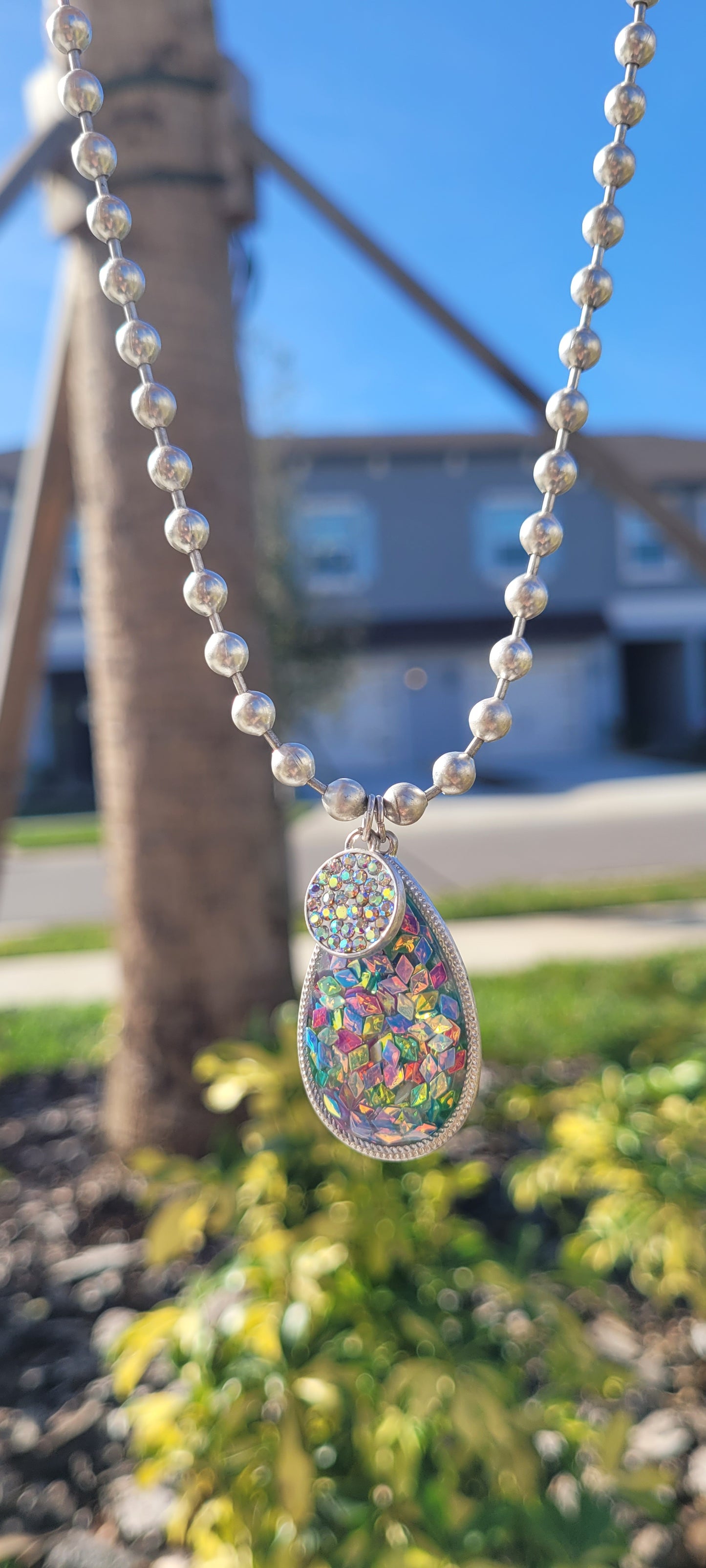 Pink Panache necklace Color: Silver ball chain necklace with multi-color confetti filled acrylic teardrop with AB pave circle charm Limited supply!