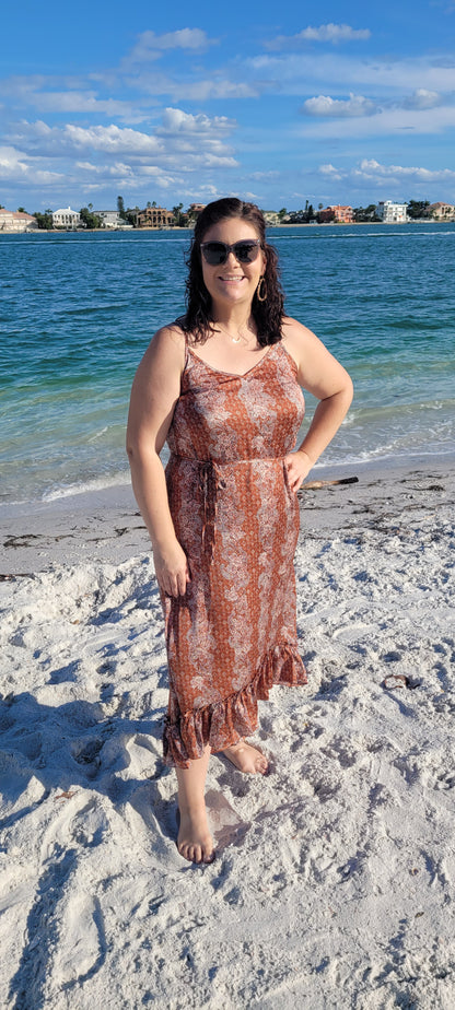 Make a statement in the "Neriah Rust Paisley Slip Midi Dress"! This stunning high-low dress features a classic paisley pattern, a flouncy ruffle hem, adjustable spaghetti straps, and a thin waist tie strap for you to cinch and flaunt. So, go ahead and show off your gorgeously rustic style! Sizes small through large.