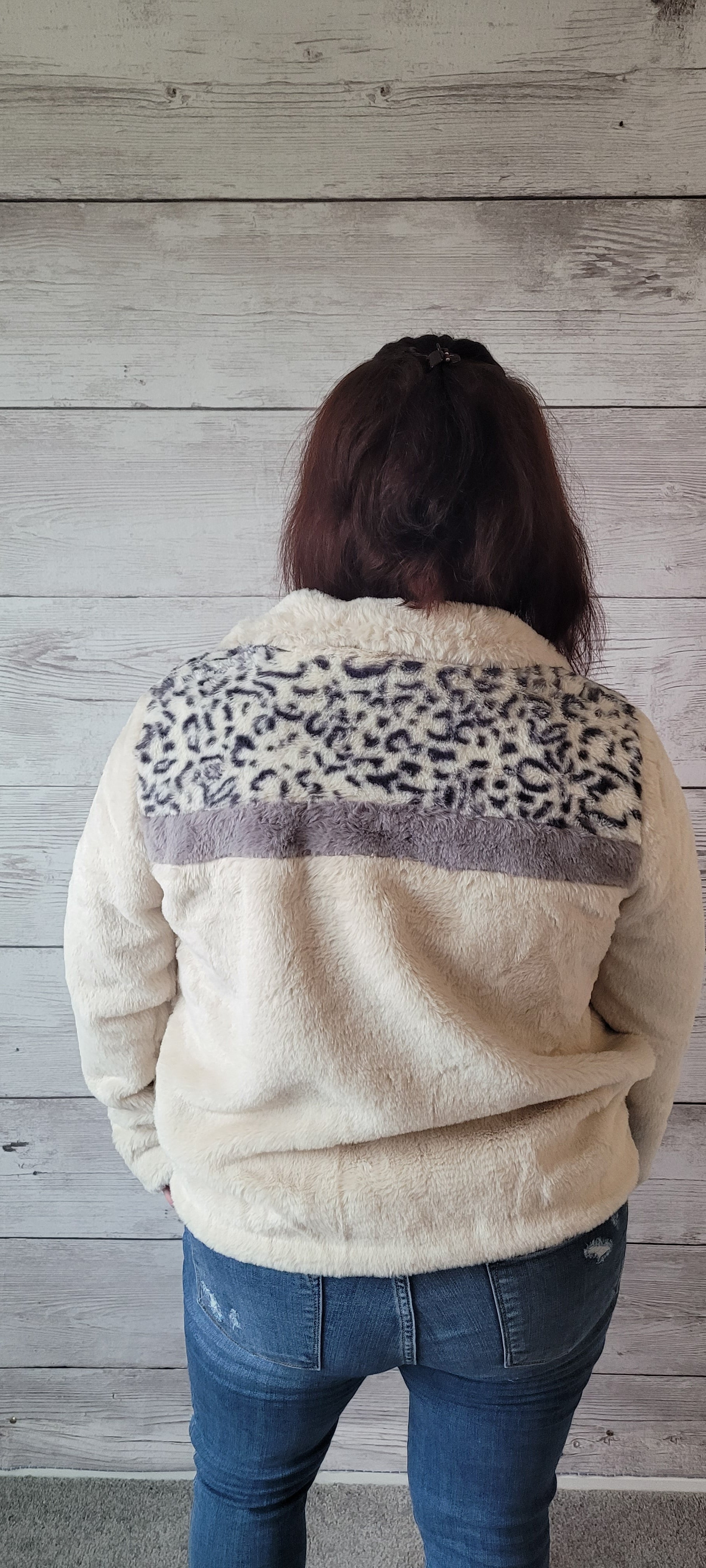 The "Raegan Ivory Faux Fur Jacket" is a luxurious treat for your wardrobe! Cozy up in this zip-front fur beauty featuring contrast leopard print for a wild touch. With its side pockets and comfy lining, you'll be ready for whatever wild night awaits you! Fur sure! Sizes small through large.