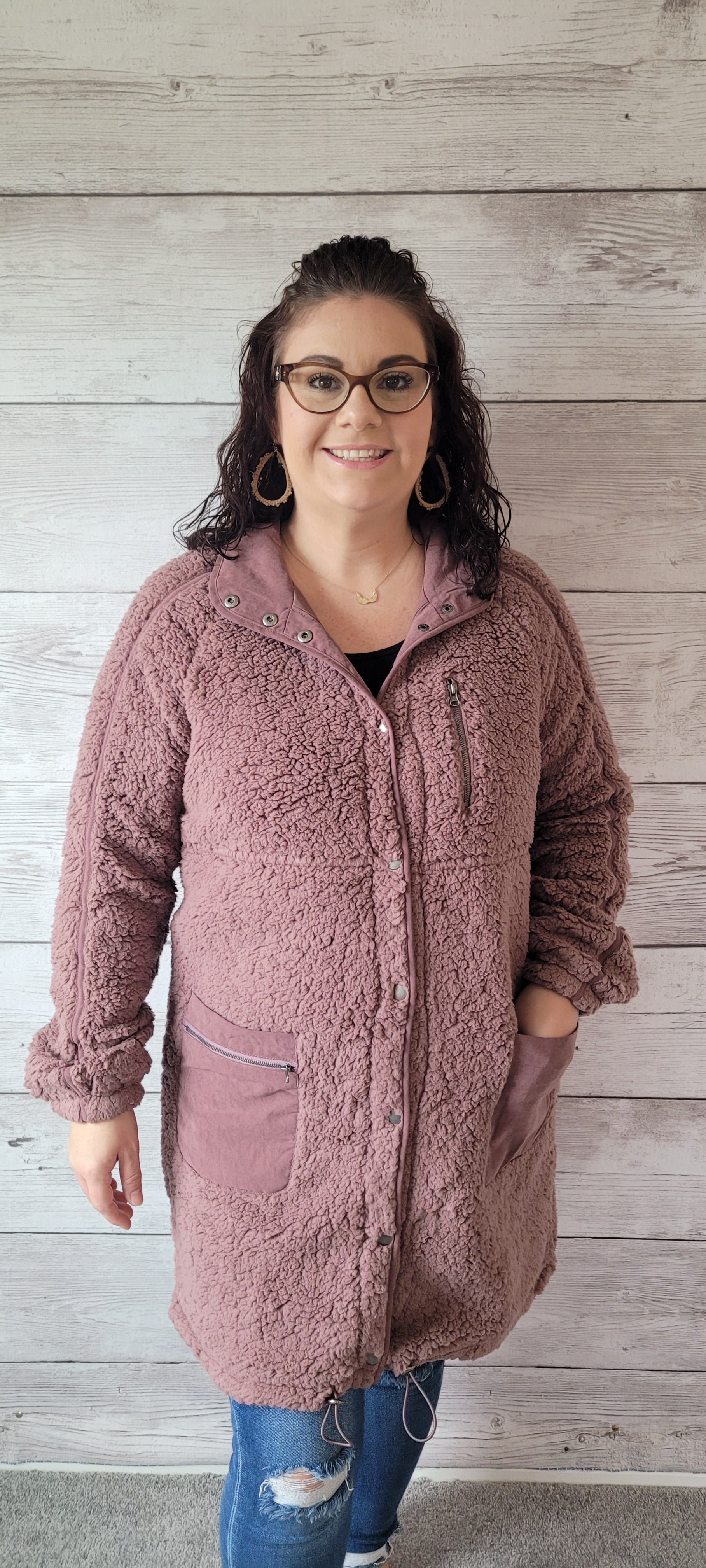 Keep snug and stay stylish with the "Maggie Mauve Fleece Jacket"! With metal snap button front closure, zippered pockets, contrast trim, and drawstring hem, you'll look totally 'snow'-tastic! Cozy up and stay oh-so chic! Sizes small through large.