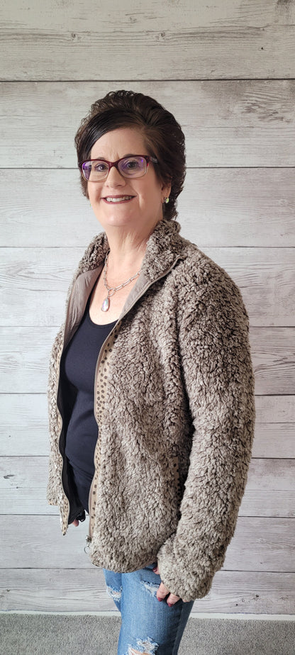 Stay warm and stylish with the "Brooke Olive Fleece Jacket"! Perfect for those chilly days, this cozy and oh-so-soft jacket has printed trim detail, side pockets, and a lined interior. It's zipped-up fun with a fashion twist! Sizes small through large.