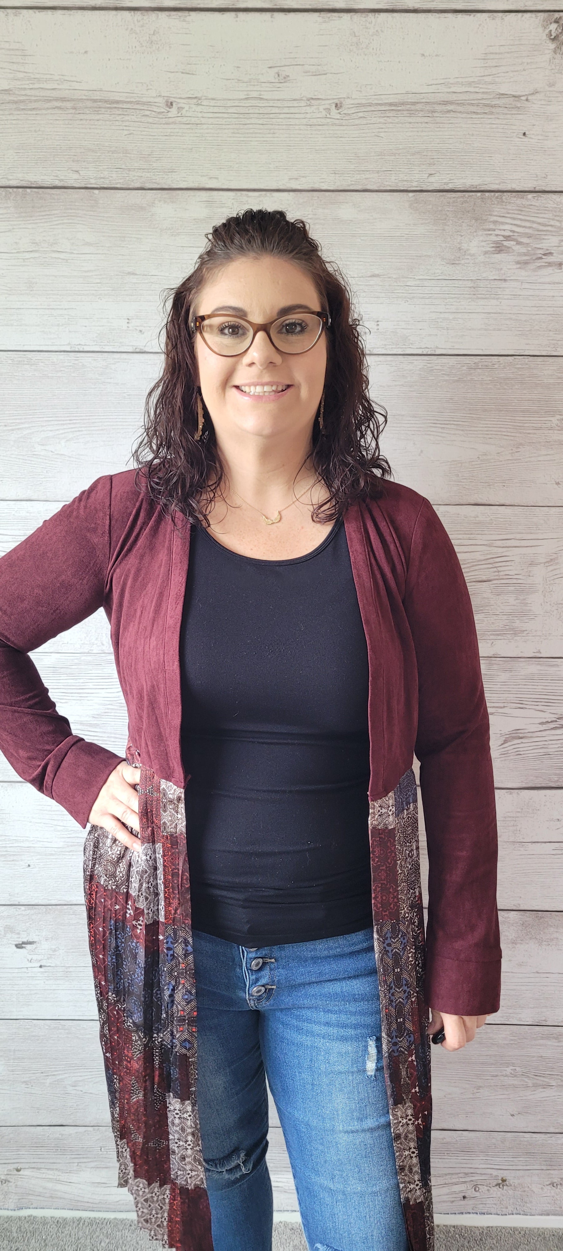 Rock that western flair with Julianna, an ultra-cool mix media cardigan. This burgundy faux suede number will have you feeling fancy with its pleated bottom, long sleeve, and tie strap around the waist. You'll be all set for a night out on the town! Sizes small through large.