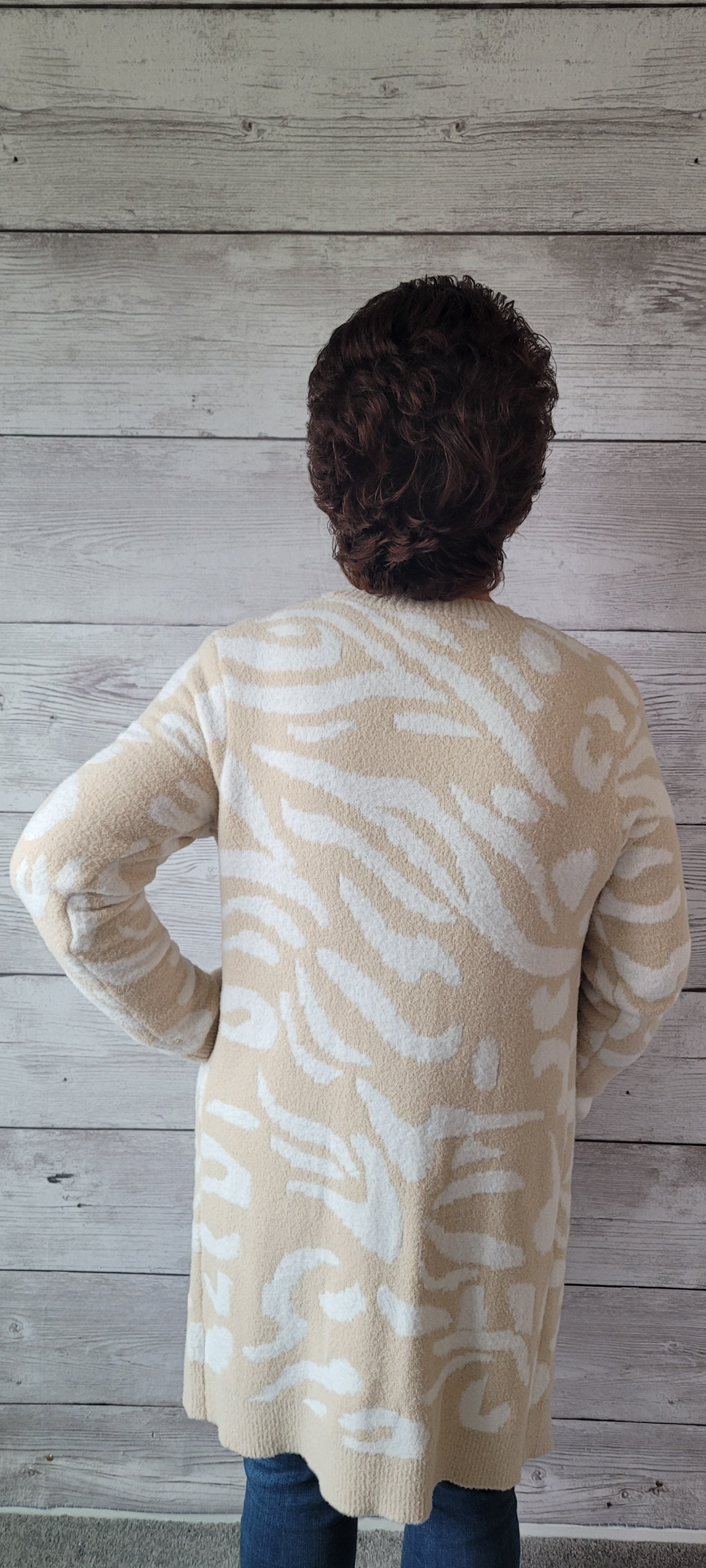 Snuggle up and stay warm in this very soft Dylan beige and ivory animal print cardigan! Flaunt your wild side and show off the cozy vibes in the most stylish way. (It's the purr-fect layering piece!) Sizes small through large.