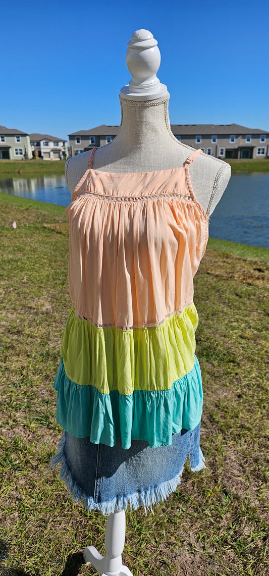 “Tutti Frutti” is a vibrant color block tank top. This tank top features three tiers of color (sherbet orange, lime green, light teal), adjustable straps, elastic back, pleated flare top and cute peekaboo lace trim. This top does not have stretch, but is loose fitting and longer in length. It is super lightweight and breathable. Sizes small through large.