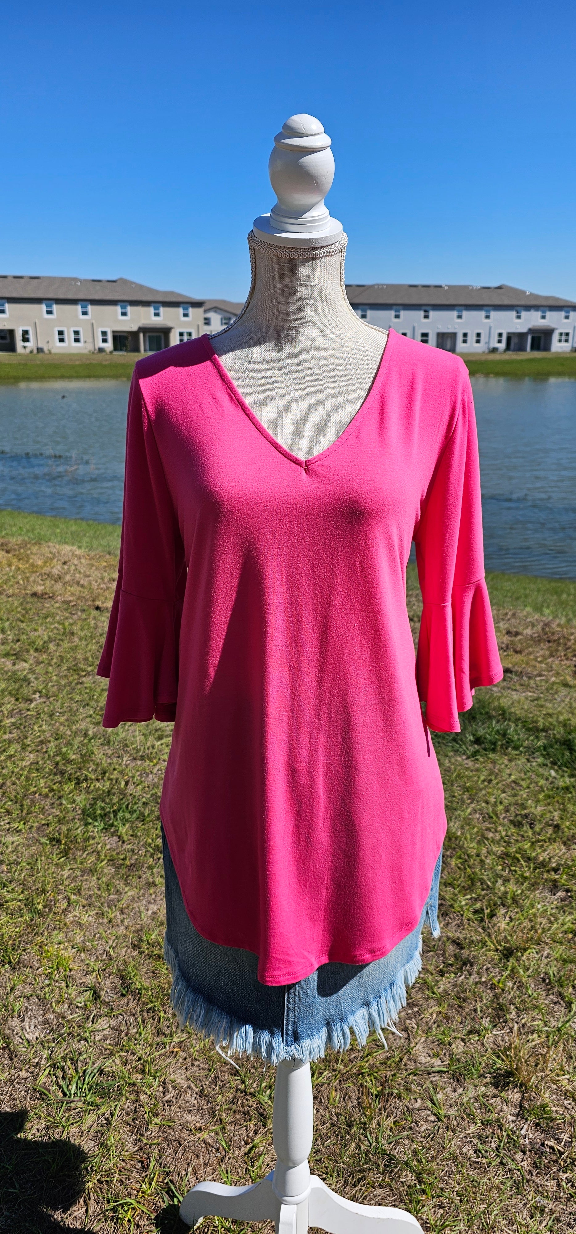 This is a comfy and casual top! This is a ruffled bell sleeve, rounded hem, v-neck shirt. Color is fuchsia. Easy to dress up or down. Pair with your favorite pair of denim jeans, shorts, skirt, or dress pants. Don’t be afraid to get creative! Sizes small through x-large.