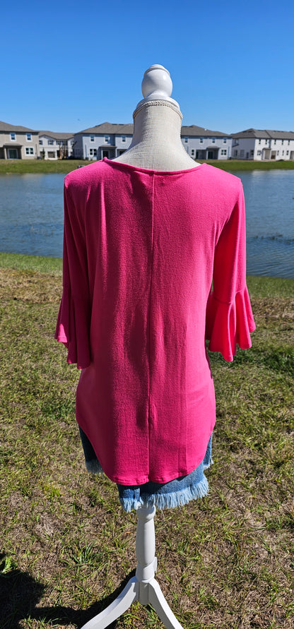 This is a comfy and casual top! This is a ruffled bell sleeve, rounded hem, v-neck shirt. Color is fuchsia. Easy to dress up or down. Pair with your favorite pair of denim jeans, shorts, skirt, or dress pants. Don’t be afraid to get creative! Sizes small through x-large.