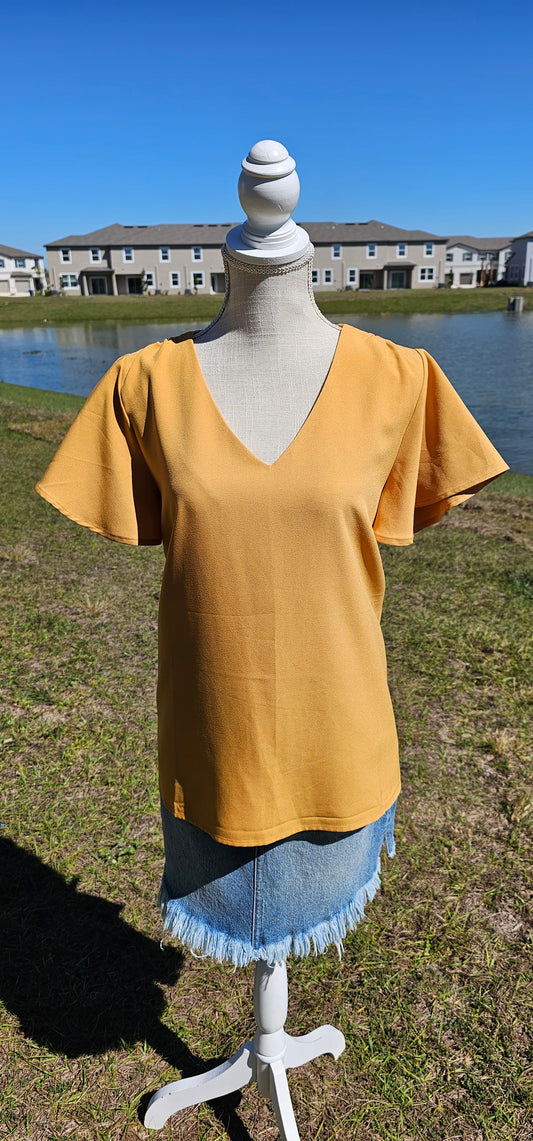 Harvest some style in this Dandelion Fields Golden Mustard Top! Featuring a woven flutter sleeve v-neck - it's the perfect outfit choice to spice up any look! Guaranteed to make you stand out like a ray of sunshine. Sizes small through x-large.