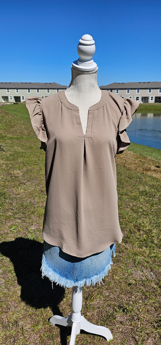 This Flutter Sleeve Notched Neck Blouse is an easy way to add a feminine touch to your casual style. The notched neckline and short sleeves are classic touches while the flounce sleeves give it an effortless feel. Sizes small through x-large.