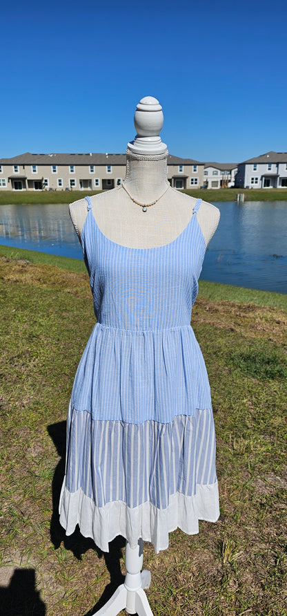 “Beach Hopper” is a midi dress with layers of tiered striped prints. This dress features a white ruffled hemline, adjustable straps, zipper on side with clasp closure, scoop neckline and back, it is lined and does not have stretch. There are two functional pockets. This dress is perfect for a beach getaway! Sizes small through large.