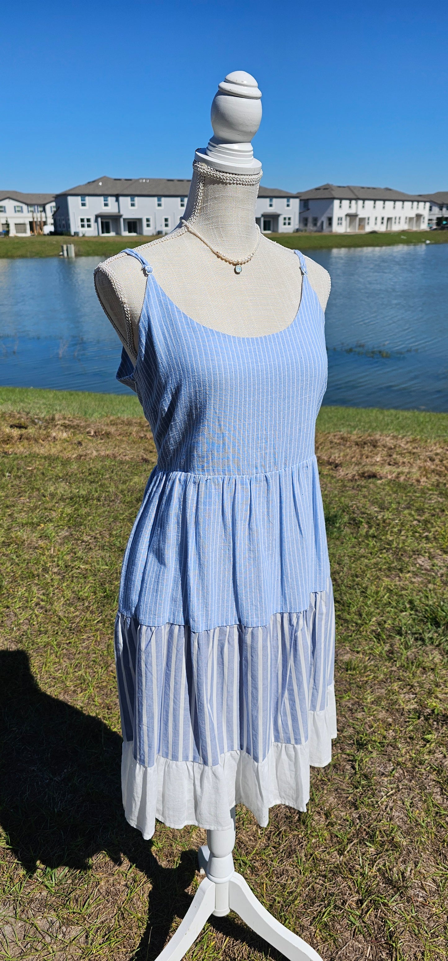 “Beach Hopper” is a midi dress with layers of tiered striped prints. This dress features a white ruffled hemline, adjustable straps, zipper on side with clasp closure, scoop neckline and back, it is lined and does not have stretch. There are two functional pockets. This dress is perfect for a beach getaway! Sizes small through large.