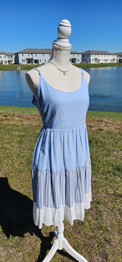 “Beach Hopper” is a midi dress with layers of tiered striped prints. This dress features a white ruffled hemline, adjustable straps, zipper on side with clasp closure, scoop neckline and back, it is lined and does not have stretch. There are two functional pockets. This dress is perfect for a beach getaway! Sizes small through large.