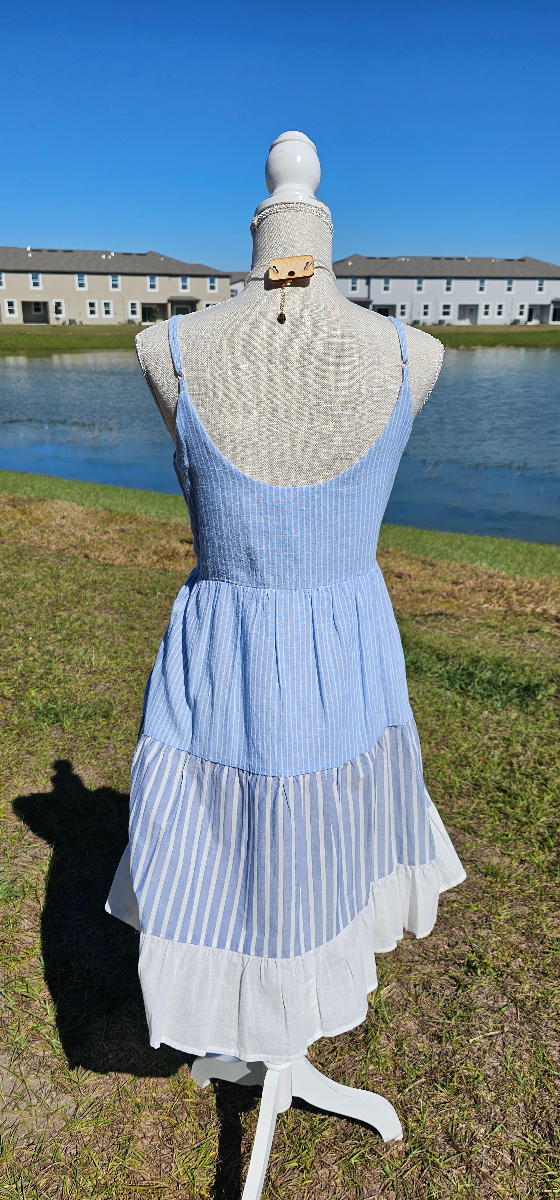 “Beach Hopper” is a midi dress with layers of tiered striped prints. This dress features a white ruffled hemline, adjustable straps, zipper on side with clasp closure, scoop neckline and back, it is lined and does not have stretch. There are two functional pockets. This dress is perfect for a beach getaway! Sizes small through large.