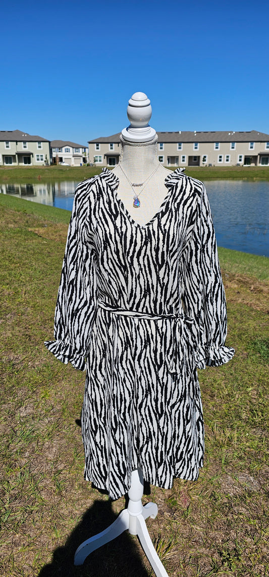 Get in touch with your bold and wild side! This dress is classy, sassy, and badassy! Colors are black and off white. This zebra print dress features a ruffle collar, ¾ balloon sleeves with ruffles, waist tie, v-neck, and sits below the knees. Good for a night out with the girls, office or business attire. Don’t be afraid to get creative! Sizes small through large.