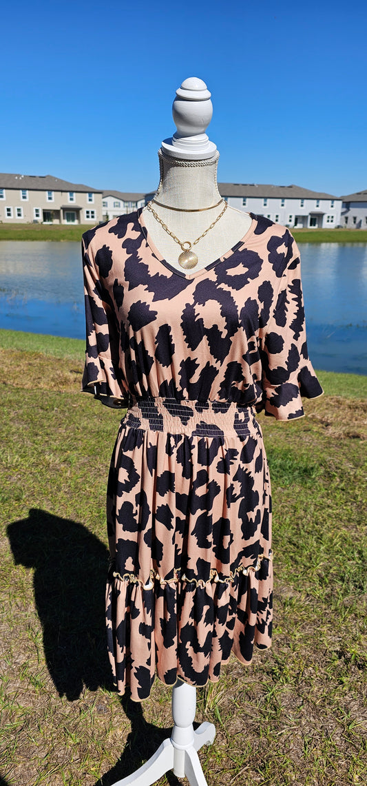 “The Wild Side” is a camel and black colored dress. This dress features a buttery soft animal print, v-neck, elastic cinched waistband, short bell sleeves with ruffles, and ruffle hemline. It sits above the knee. This dress is just as cozy as pajamas! Sizes small through large.