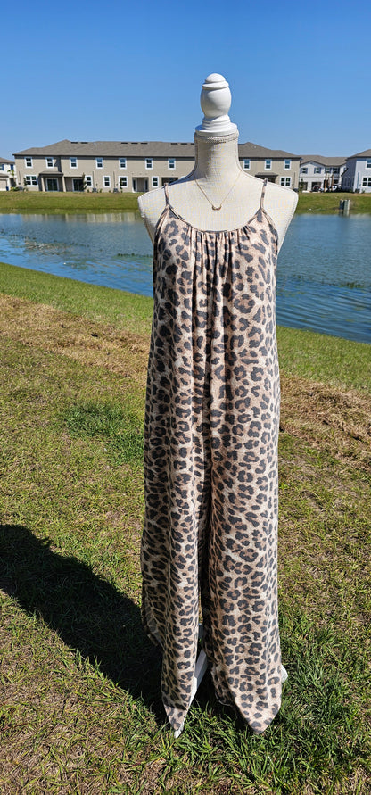 Leopard jumpsuit with side slits, adjustable straps, functional pockets. Sizes small through x-large.