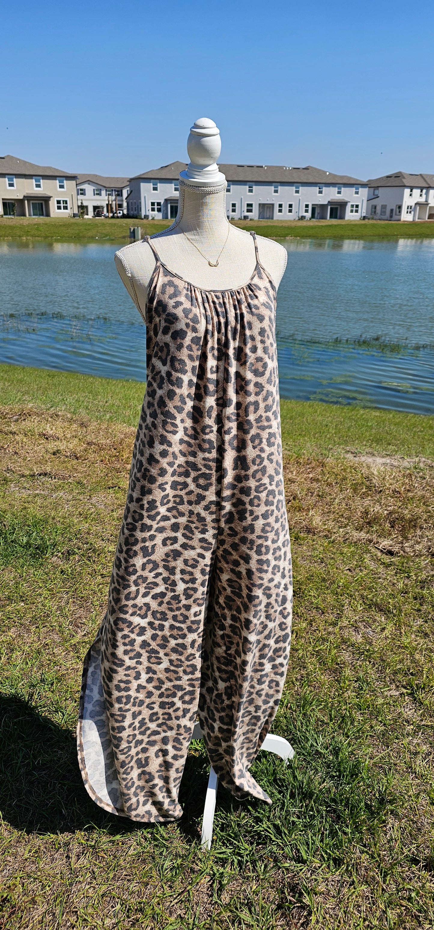 Leopard jumpsuit with side slits, adjustable straps, functional pockets. Sizes small through x-large.