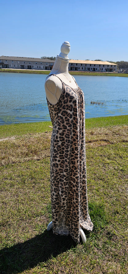 Leopard jumpsuit with side slits, adjustable straps, functional pockets. Sizes small through x-large.