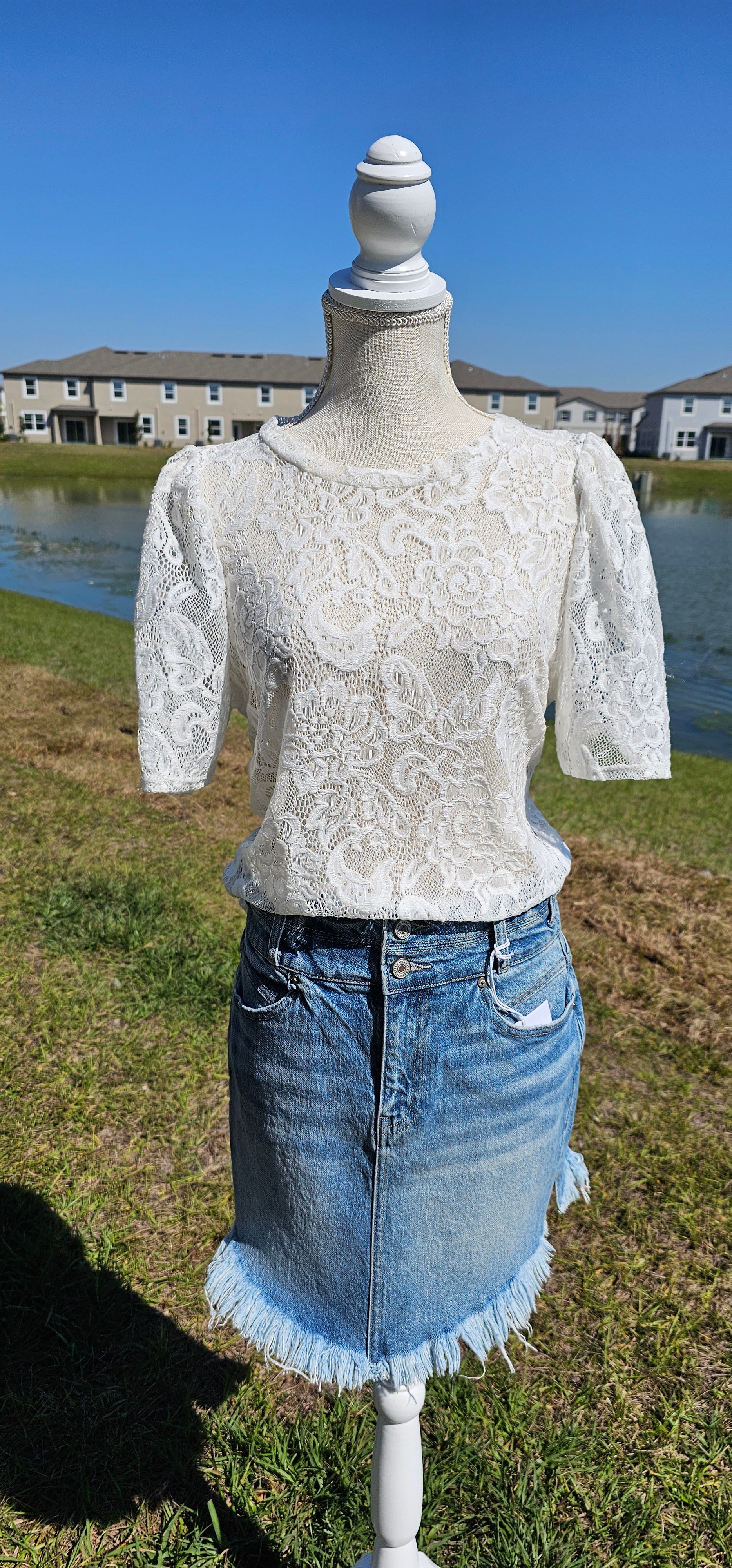 “All About The Lace” is a gorgeous white lace top. This is a short sleeve shirt, featuring floral lace print, bubble sleeves, rounded neckline and hemline. It does have stretch! Pair with your favorite cami or bralette. Sizes small through large.