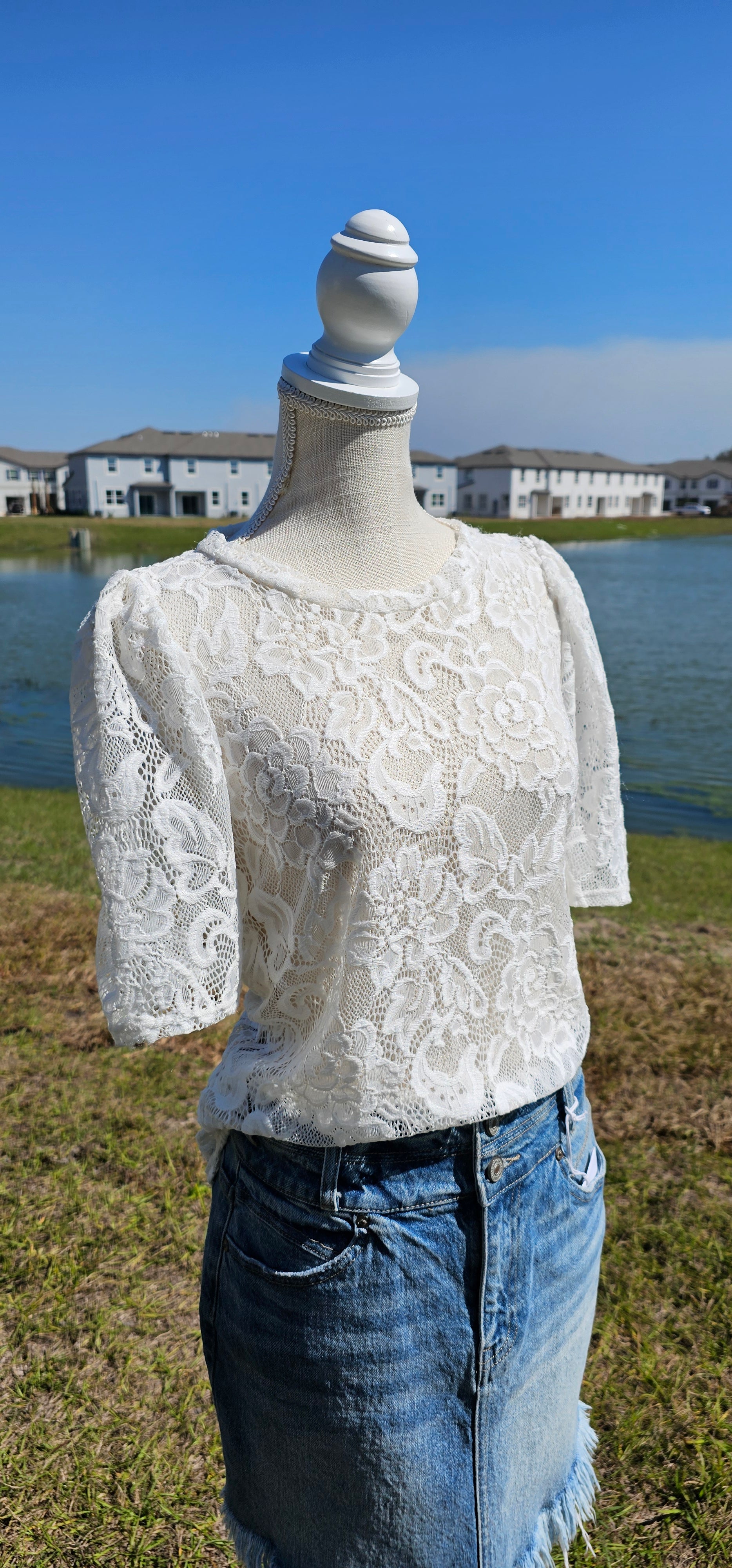 “All About The Lace” is a gorgeous white lace top. This is a short sleeve shirt, featuring floral lace print, bubble sleeves, rounded neckline and hemline. It does have stretch! Pair with your favorite cami or bralette. Sizes small through large.