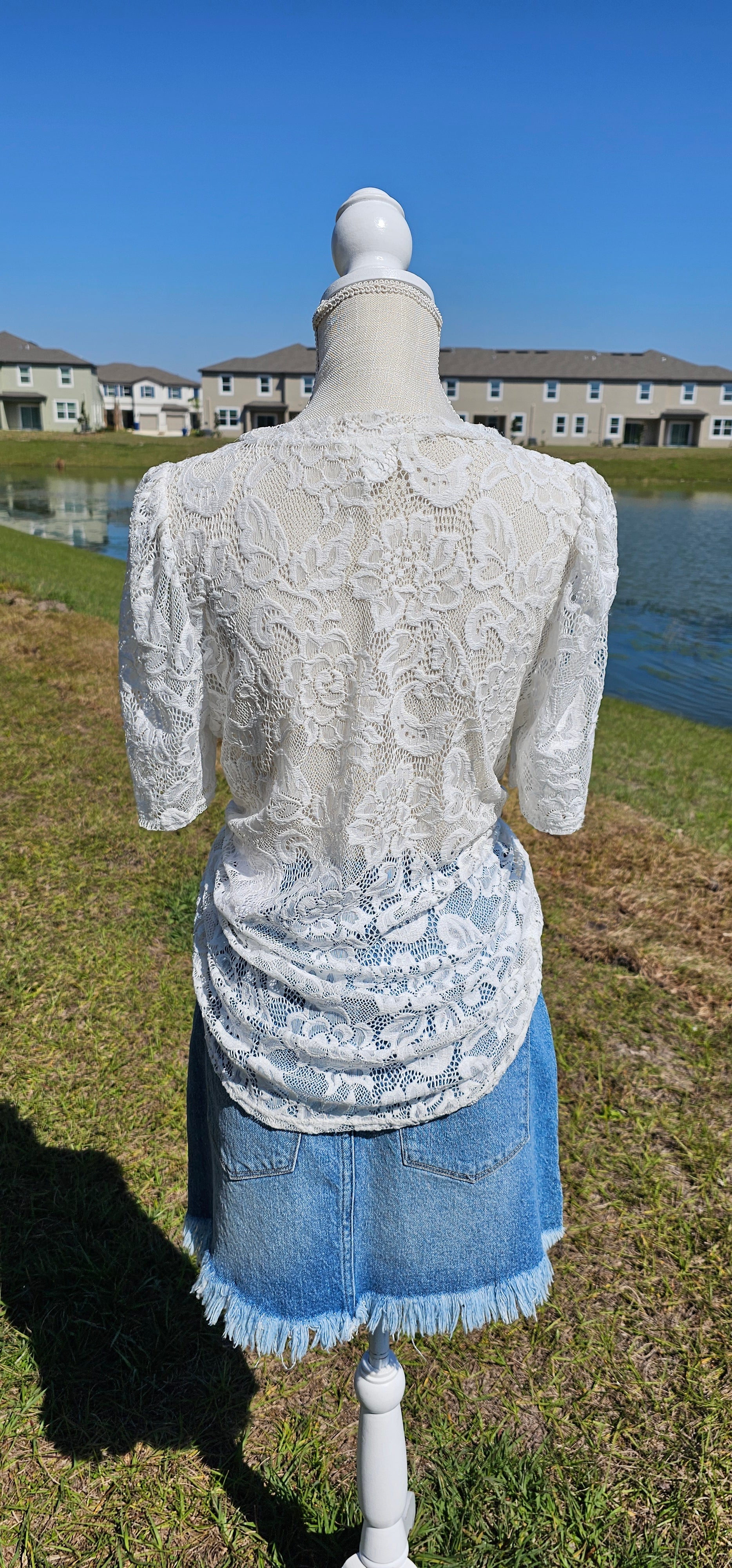 “All About The Lace” is a gorgeous white lace top. This is a short sleeve shirt, featuring floral lace print, bubble sleeves, rounded neckline and hemline. It does have stretch! Pair with your favorite cami or bralette. Sizes small through large.