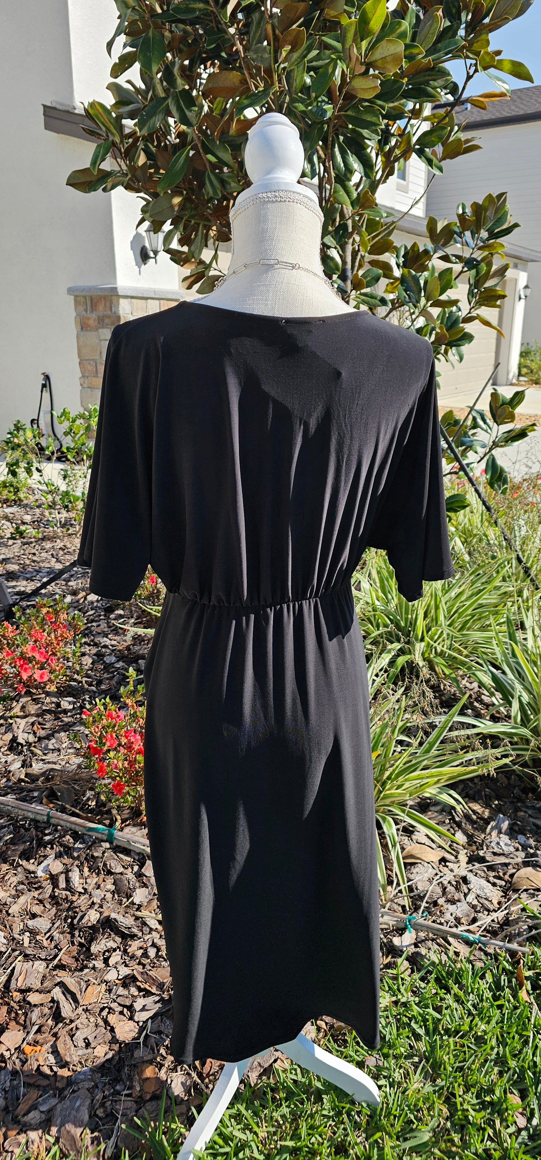 Style your look with this midi flutter sleeve dress. It features a surplice neckline and asymmetrical detail, making it a versatile style that's perfect for work or weekend wear. Sizes small through 3x-large.
