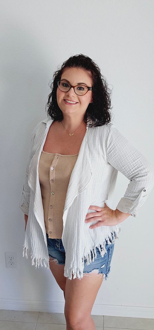 Meet the perfect blend of playful and practical - striped fringe hem cardigan! With its trendy striped design and raw fringe hem, you'll stand out in style. Plus, the rolled functional button cuff and collar add a touch of functionality to this unique piece. Stay effortlessly chic in this cardigan! Sizes small through large.