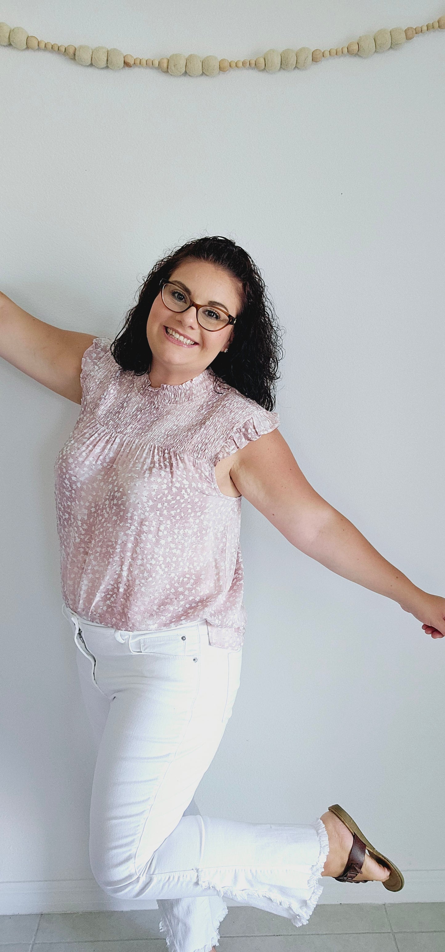 Flaunt your playful and flirty side with this cute top. The smocked neckline and ruffled cap sleeves add a touch of whimsy, while the side slits and textured fabric offer comfort and style. Perfect for any occasion, this top will elevate your wardrobe. Sizes small through large.