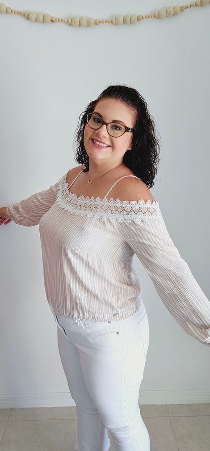 Unleash your playful side with this adorable top! This tan and off-white top features delicate lace trim and a fun bubble silhouette, making it perfect for any occasion. Embrace a unique and quirky style with this statement piece. Sizes small through large.