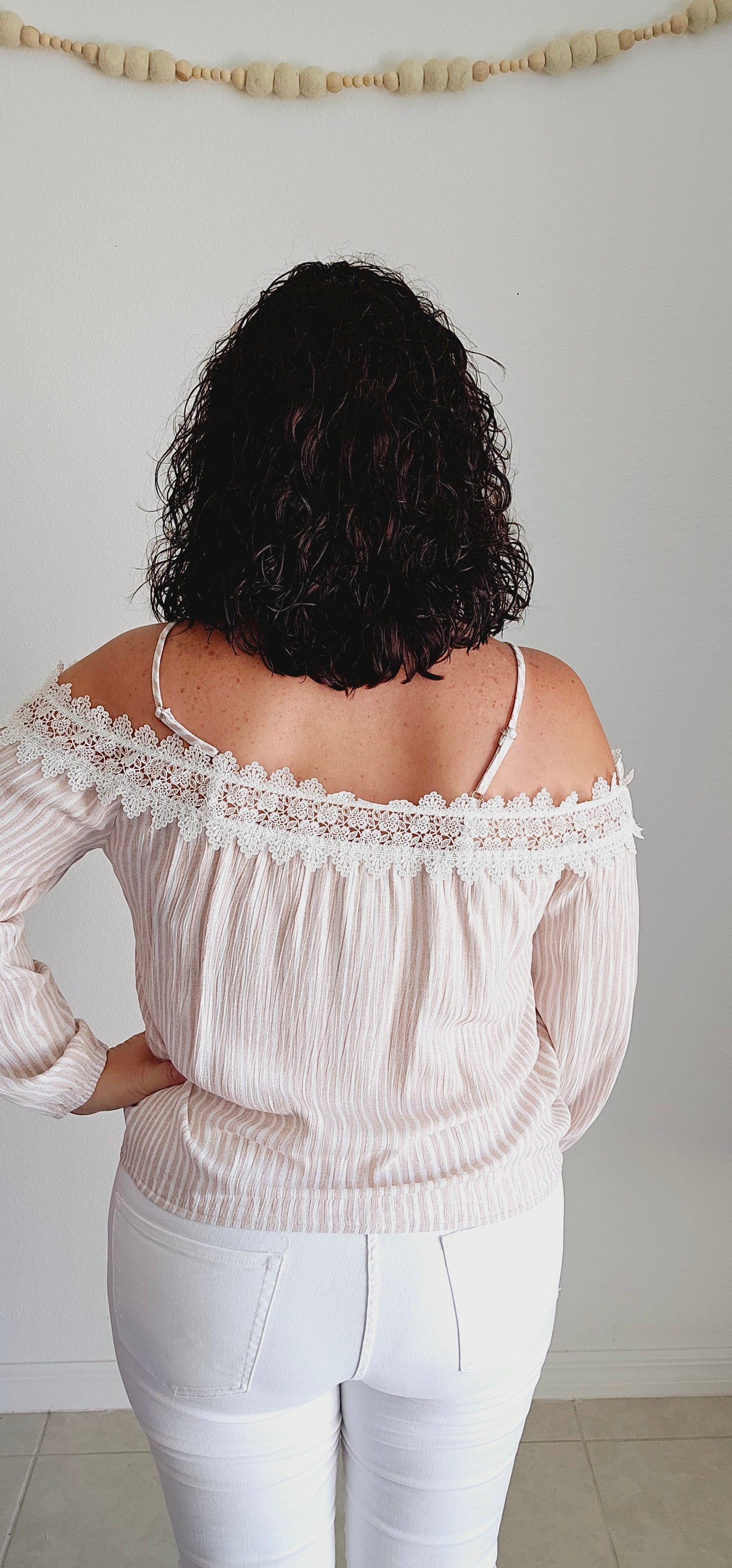 Unleash your playful side with this adorable top! This tan and off-white top features delicate lace trim and a fun bubble silhouette, making it perfect for any occasion. Embrace a unique and quirky style with this statement piece. Sizes small through large.