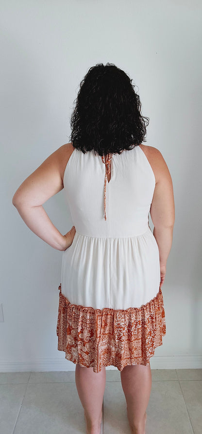 Unleash your inner free spirit. Featuring a mix of patchwork and tiered silhouette, this dress is perfect for any bohemian babe. And with a tie keyhole back and lining for comfort, you'll want to wear it all season long. How groovy! Sizes small through large.