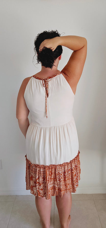 Unleash your inner free spirit. Featuring a mix of patchwork and tiered silhouette, this dress is perfect for any bohemian babe. And with a tie keyhole back and lining for comfort, you'll want to wear it all season long. How groovy! Sizes small through large.