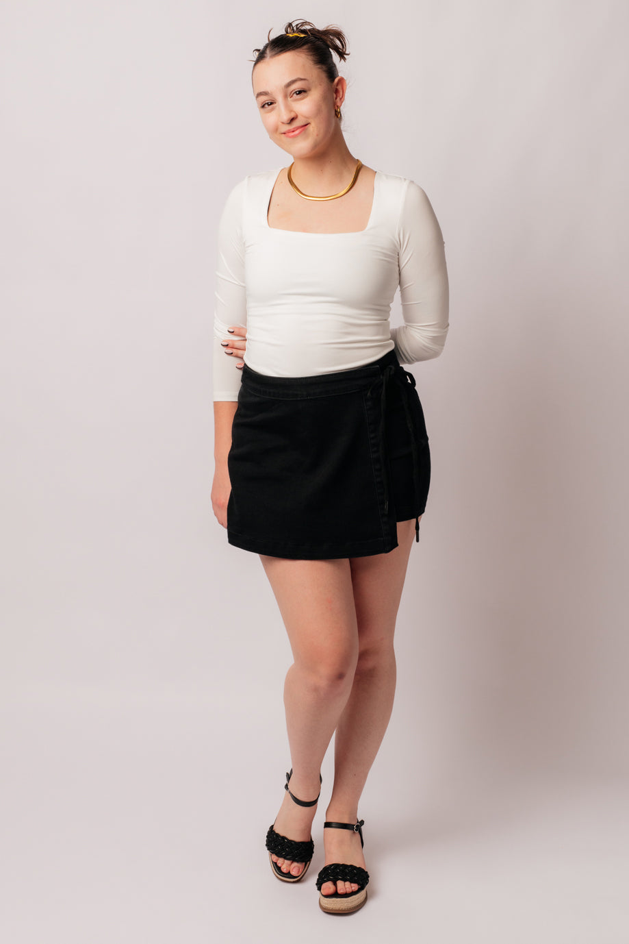 Experience elevated style with our Bentli High Rise Side Tie Denim Skort in Black. Embrace the trending skort look with this sleek and sophisticated non-distressed piece in rich black. The high rise and side tie closure create a flattering fit, making it a must-have addition to any wardrobe.&nbsp; 0-3X