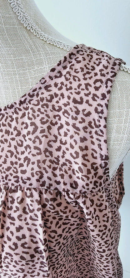 Fancy & Free is a A-line, leopard print, tiered top is sleeveless, flowy and sheer. It features a key hole back with button closure, and has a rounded neckline.&nbsp; This top is light pink with brown leopard print. It is great for vacation, an evening out, casual event, a day out on the town with your friends, or just because. Sizes small through large.